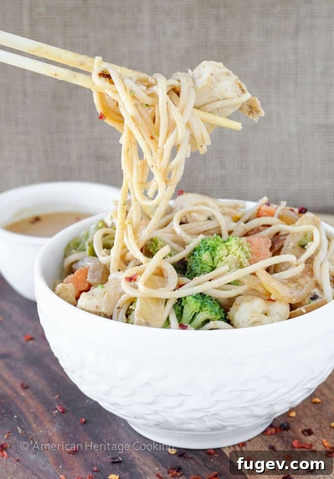 Creamy Thai Peanut Chicken Noodles 4 A vibrant assortment of fresh ingredients laid out on a wooden cutting board, including chicken, mixed vegetables, and udon noodles, symbolizing the simple and quick preparation process for the Thai Peanut Chicken Noodle Stir Fry.