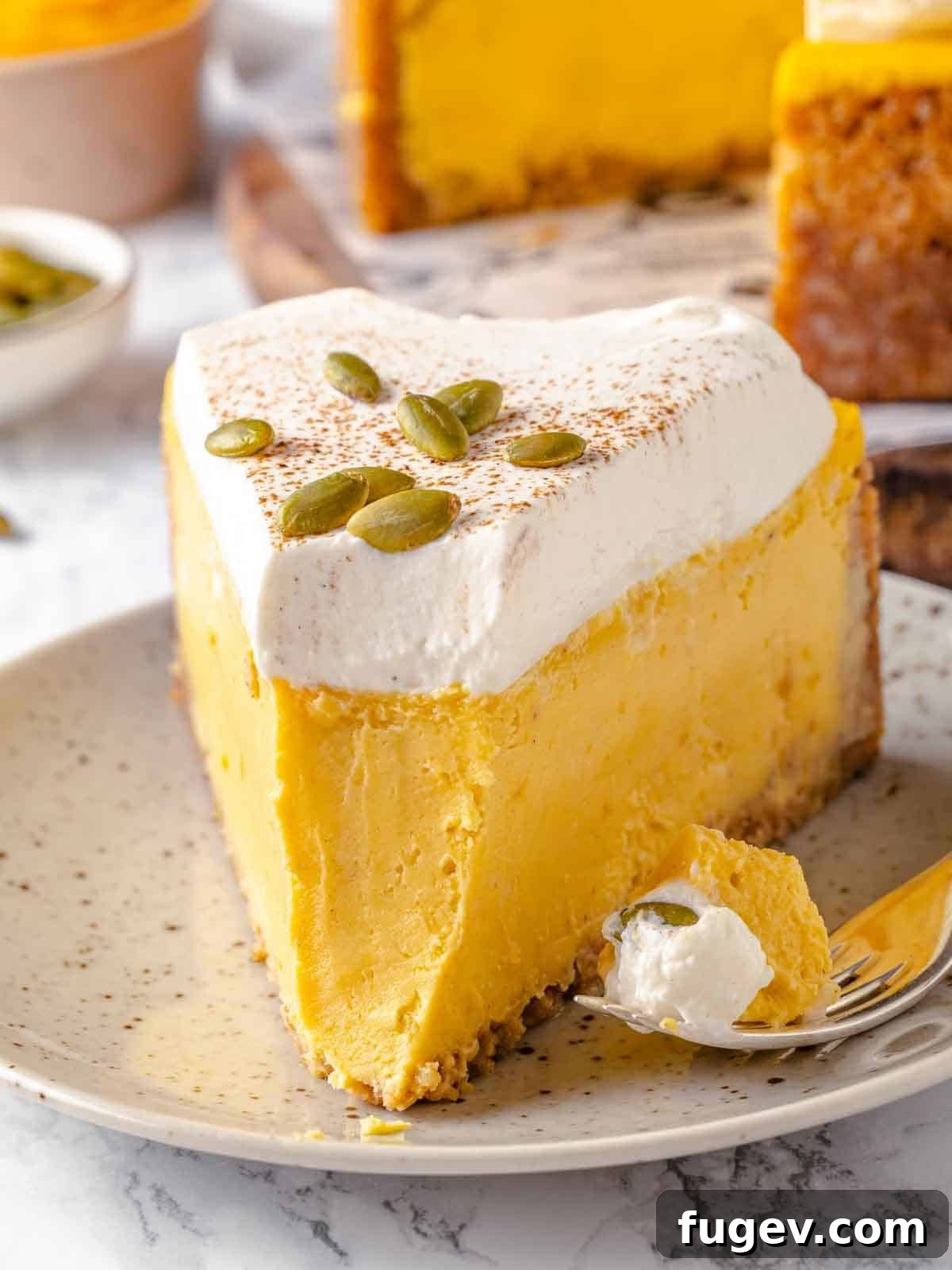 Spiced Pumpkin Cheesecake 2 A forkful of pumpkin cheesecake, showing its creamy texture and crust.