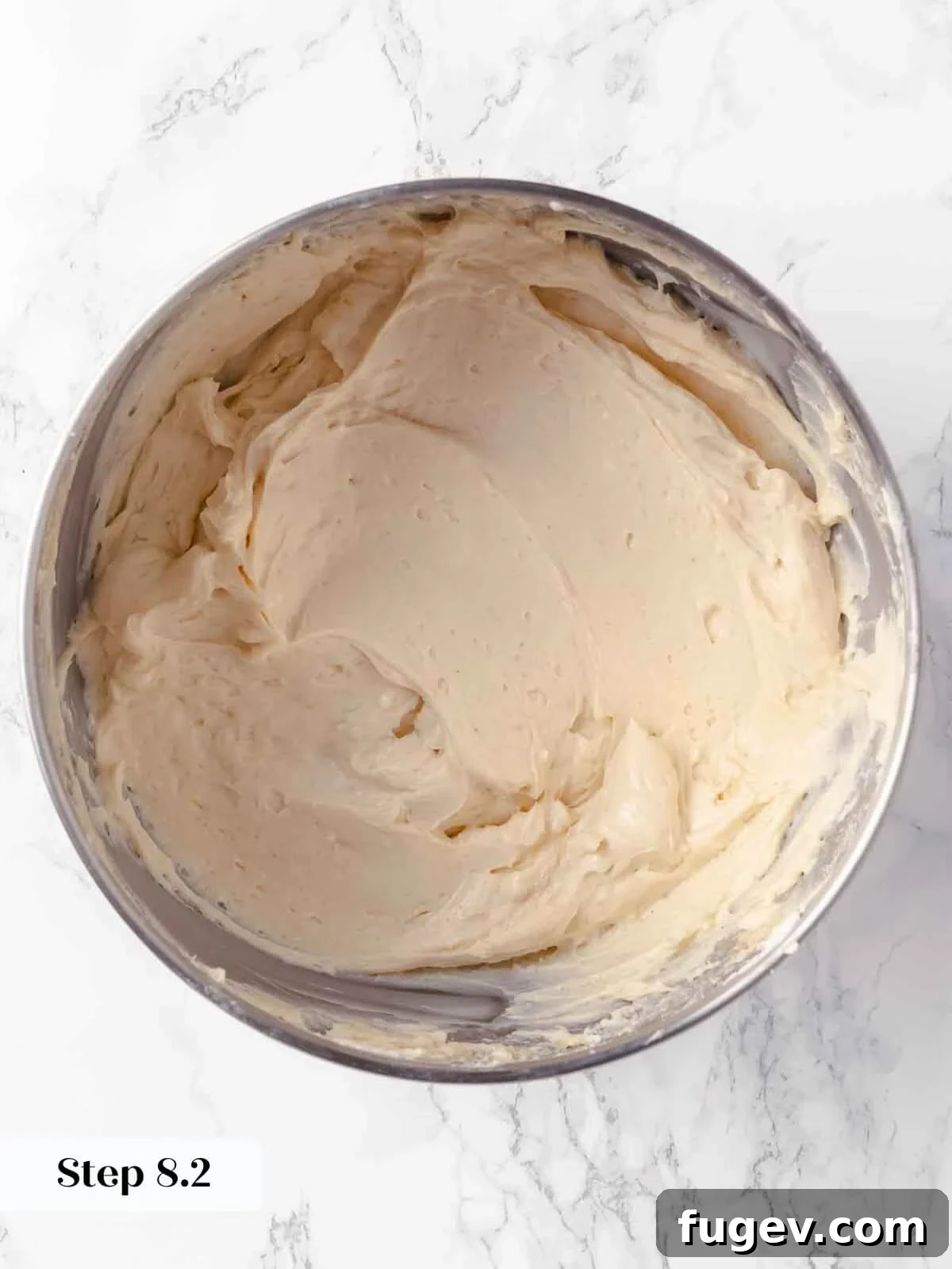 Spiced Pumpkin Cheesecake 12 Beaten sugars during the pumpkin cheesecake process, showing a uniform mixture.