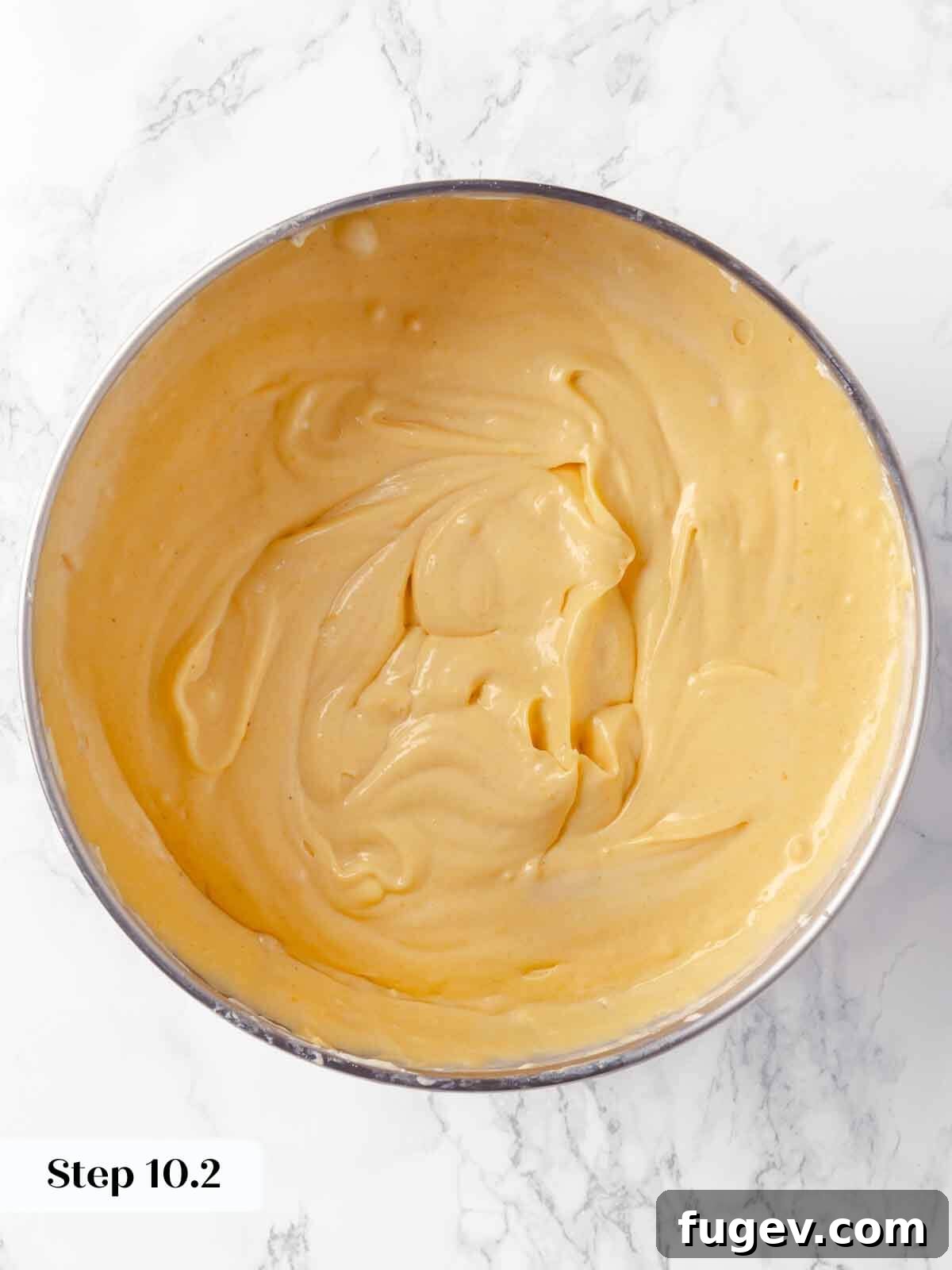 Spiced Pumpkin Cheesecake 16 Blended pumpkin during the cheesecake preparation process, showing a smooth mixture.
