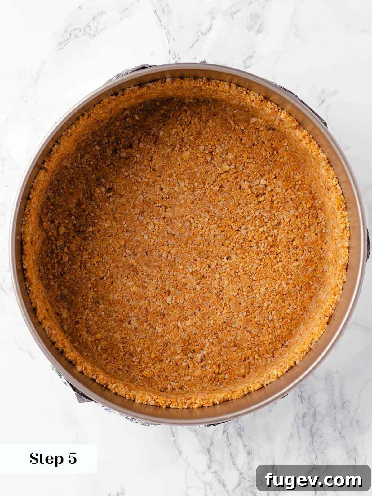 Spiced Pumpkin Cheesecake 8 The process of making pumpkin cheesecake cookie crust, pressed into the pan.