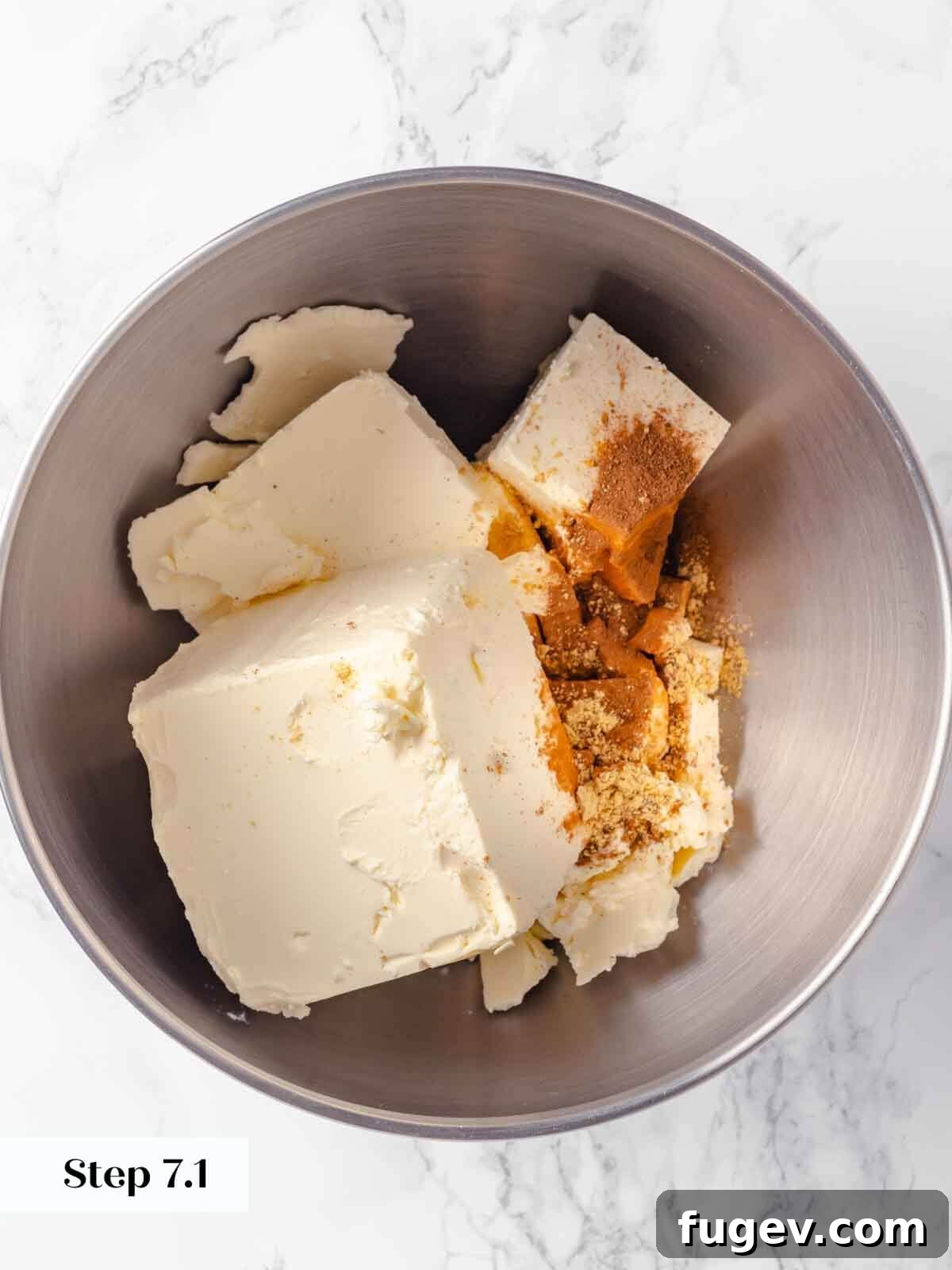 Spiced Pumpkin Cheesecake 9 Unbeaten cream cheese in a mixing bowl for pumpkin cheesecake.