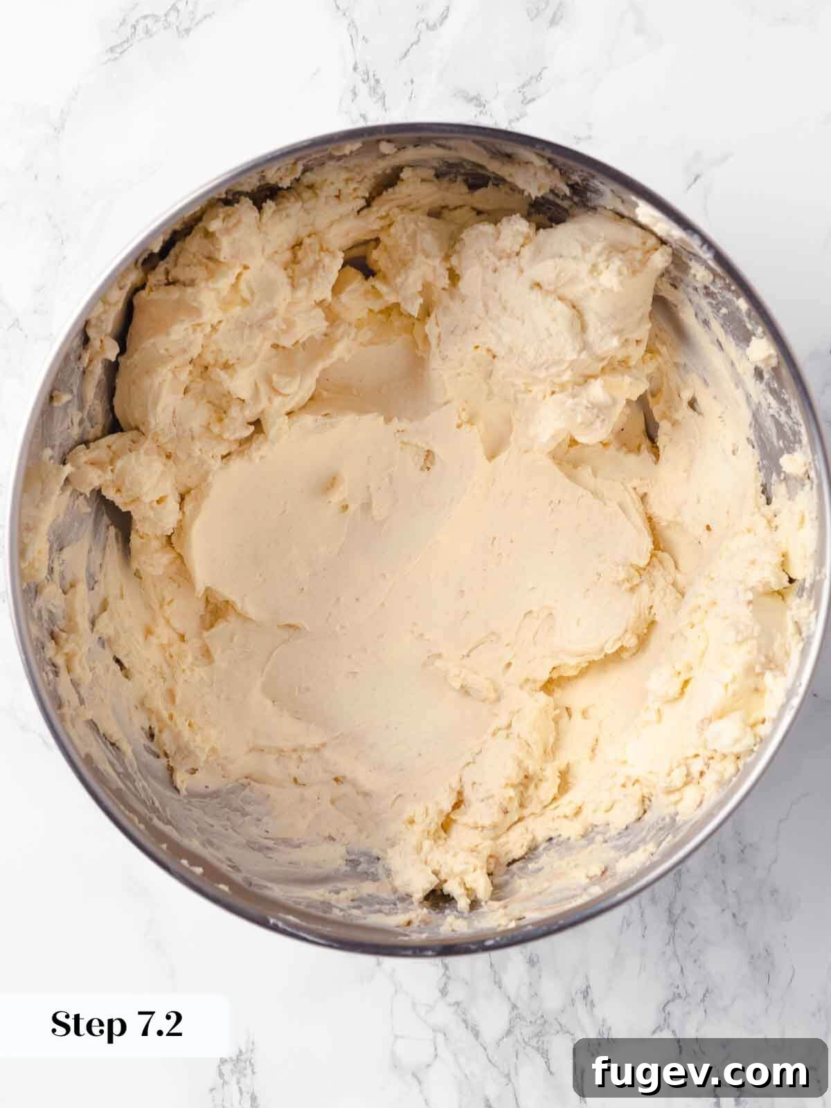 Spiced Pumpkin Cheesecake 10 Beaten cream cheese for pumpkin cheesecake, showing smooth texture.