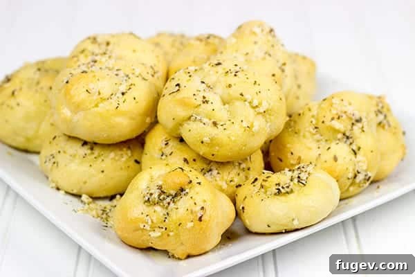 Savory Garlic Parmesan Bites 2 These Parmesan Garlic Knots are an easy, addicting appetizer! Soft homemade pizza dough is brushed with butter and sprinkled with garlic and Parmesan cheese! A perfect recipe for Game Day or any party!