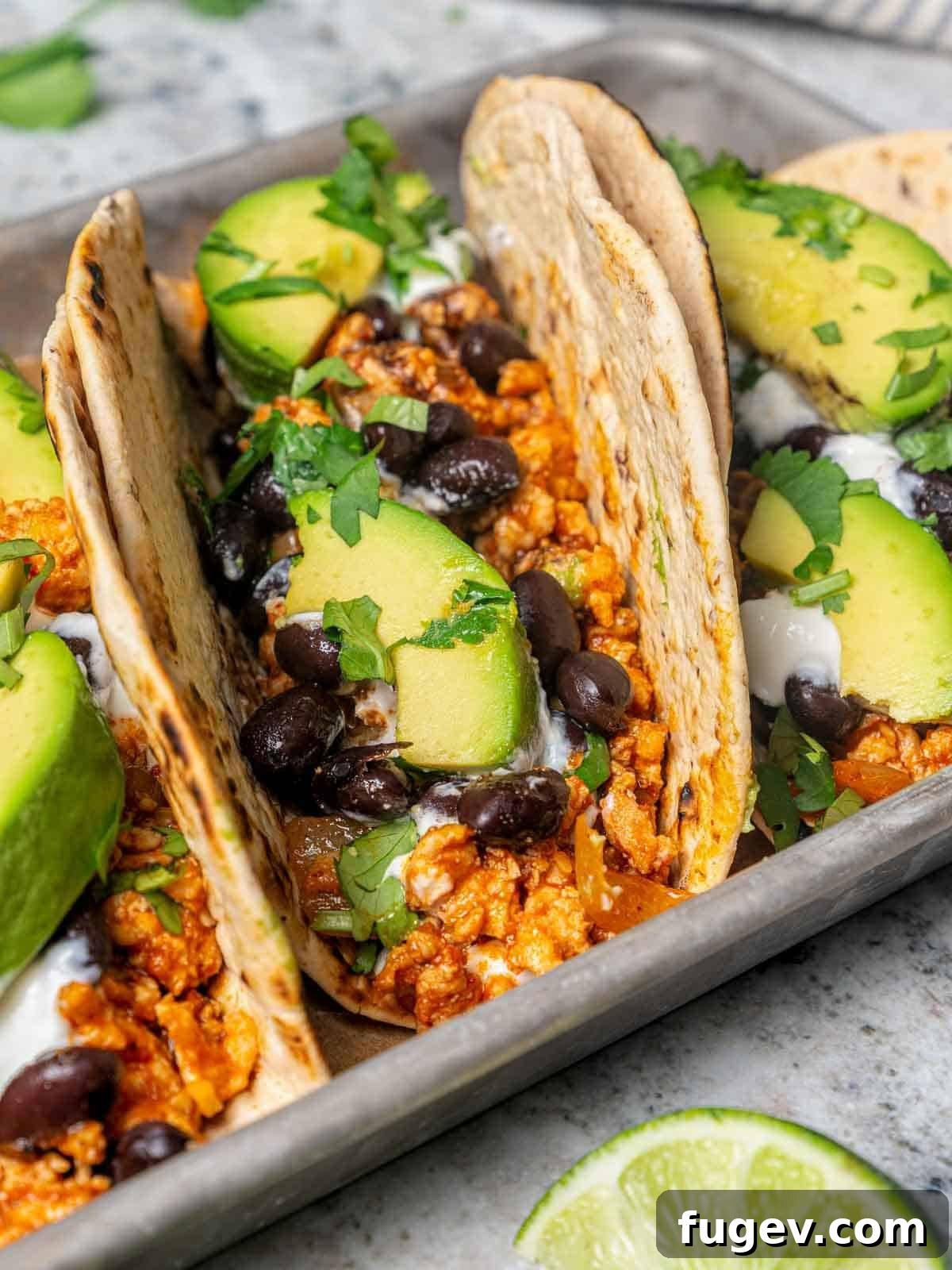 Zesty Ground Chicken Tacos 3 Close-up of a flavorful chipotle chicken taco, garnished with fresh cilantro and a hint of Greek yogurt.