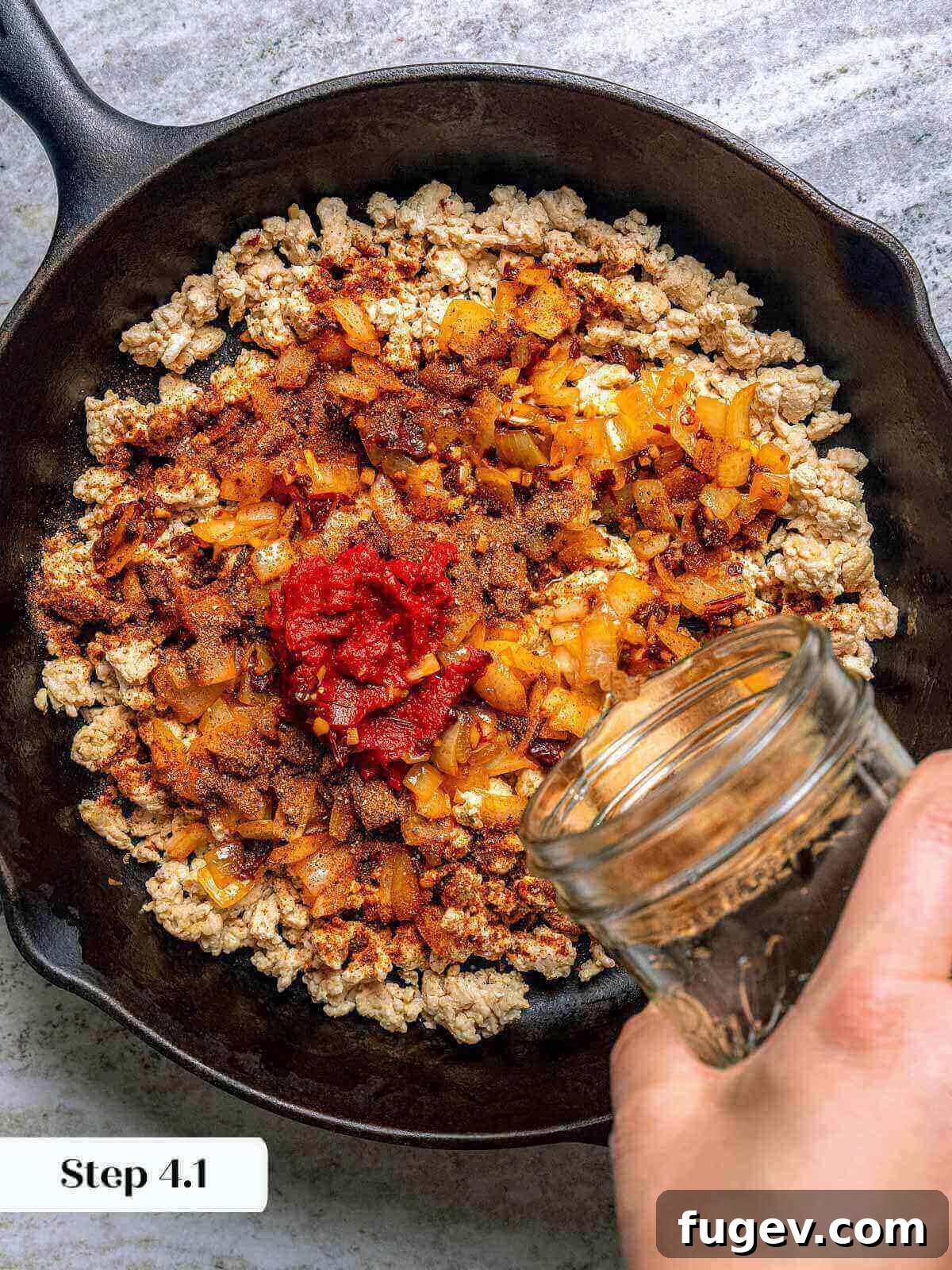 Zesty Ground Chicken Tacos 7 Adding the onion and spice mixture back into the cooked ground chicken and chorizo in a skillet.