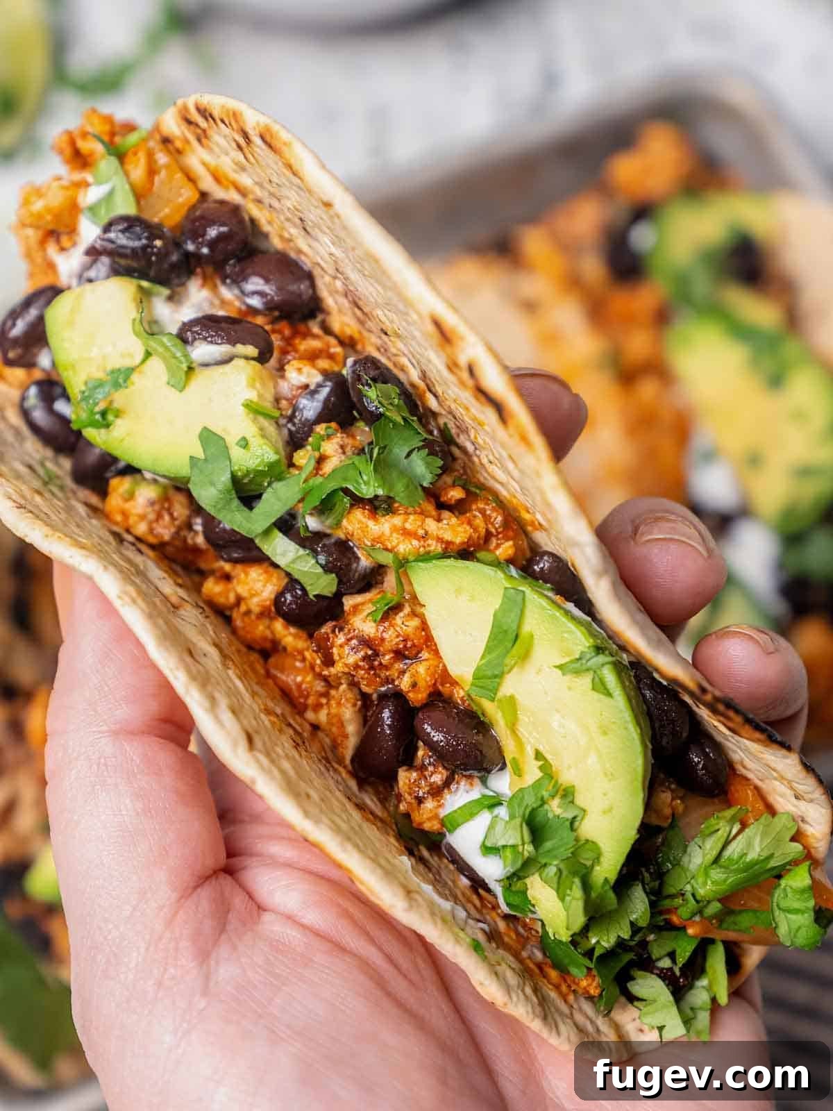 Zesty Ground Chicken Tacos 10 A hand holding a perfectly assembled ground chicken taco, ready to be enjoyed.