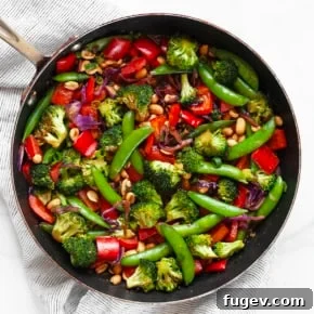 Hearty Peanut Vegetable Stir-Fry with broccoli, bell peppers, snap peas, and cabbage in a savory peanut sauce.