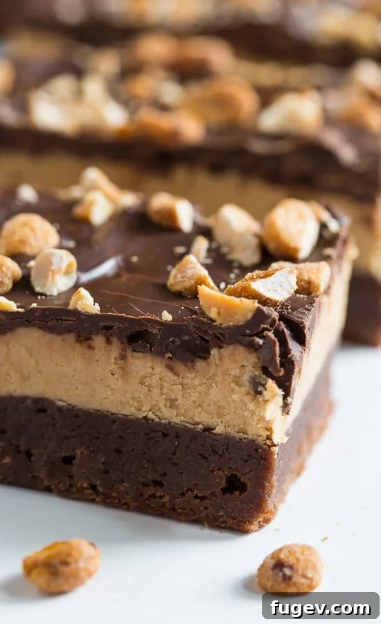 Irresistible Chocolate Peanut Butter Bars 2 Decadent side view of Triple Layer Chocolate Peanut Butter Bars showcasing each distinct layer