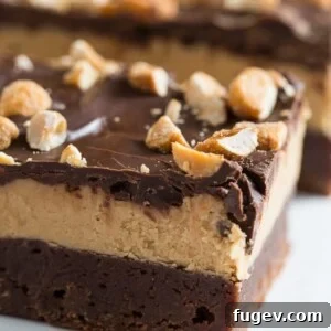 Irresistible Chocolate Peanut Butter Bars 6 A large pan of freshly baked Triple Layer Chocolate Peanut Butter Bars ready to be cut and served