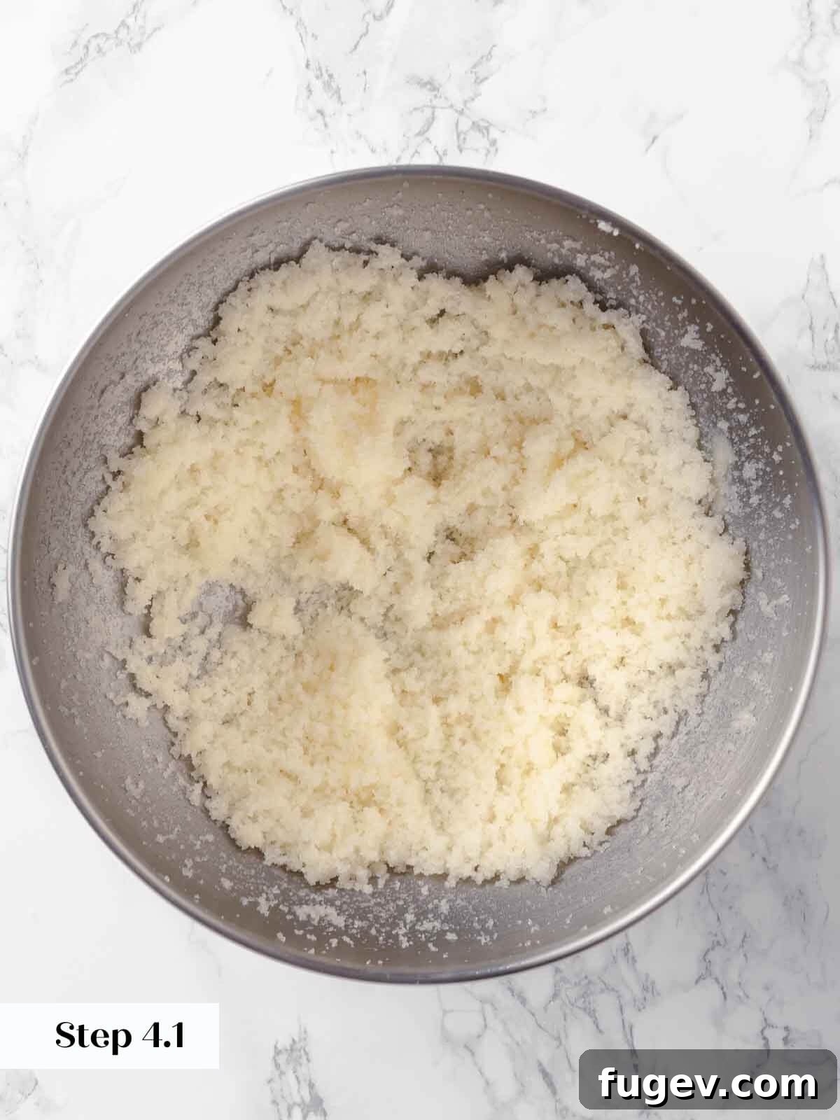 Harvest Apple Cider Donuts 8 Butter and sugar being creamed together in a stand mixer, forming a light, sandy mixture.