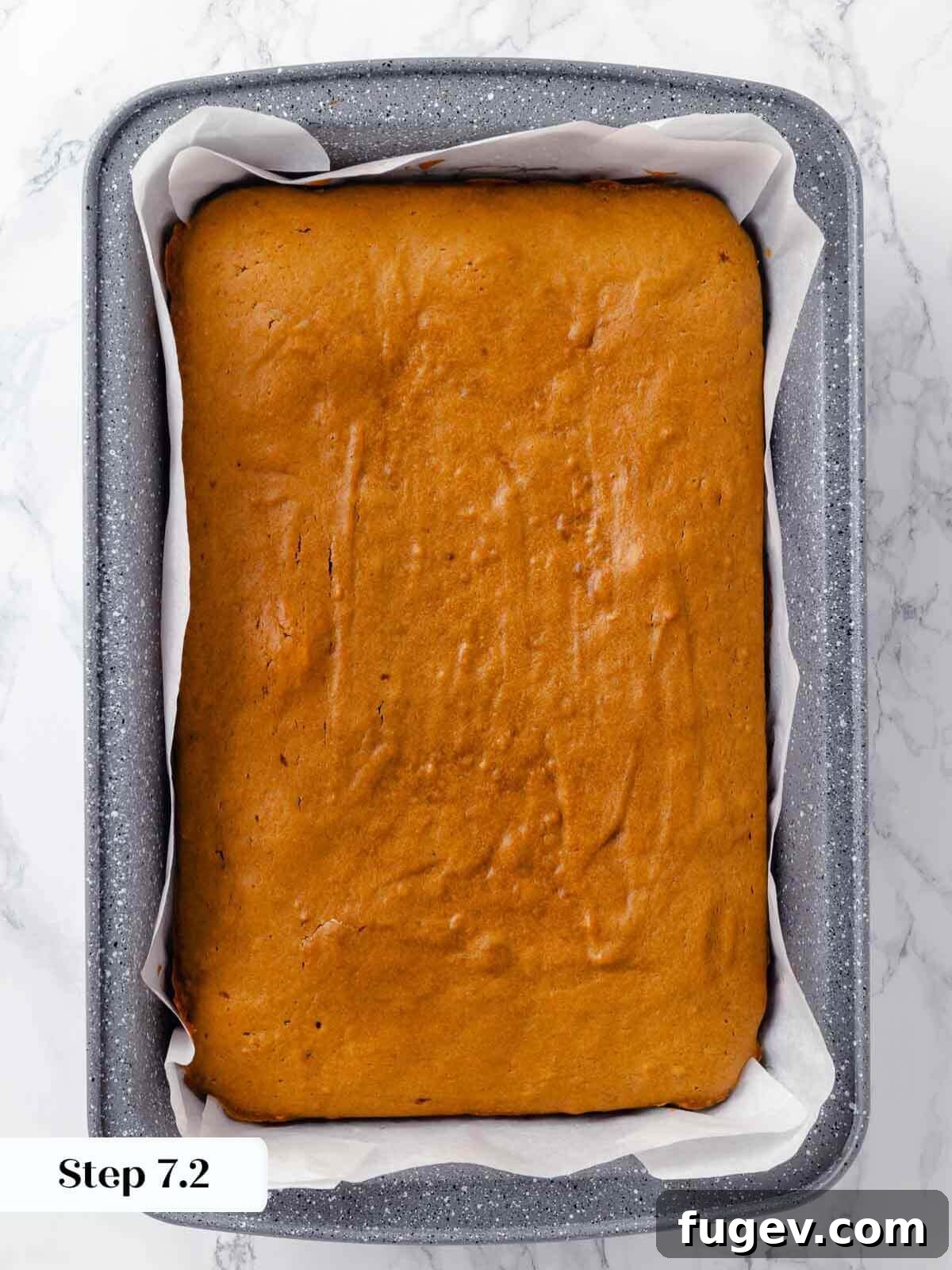 Autumn Pumpkin Spice Squares 11 Freshly baked pumpkin bars, unfrosted and unsliced, showing their golden-brown top straight from the oven.