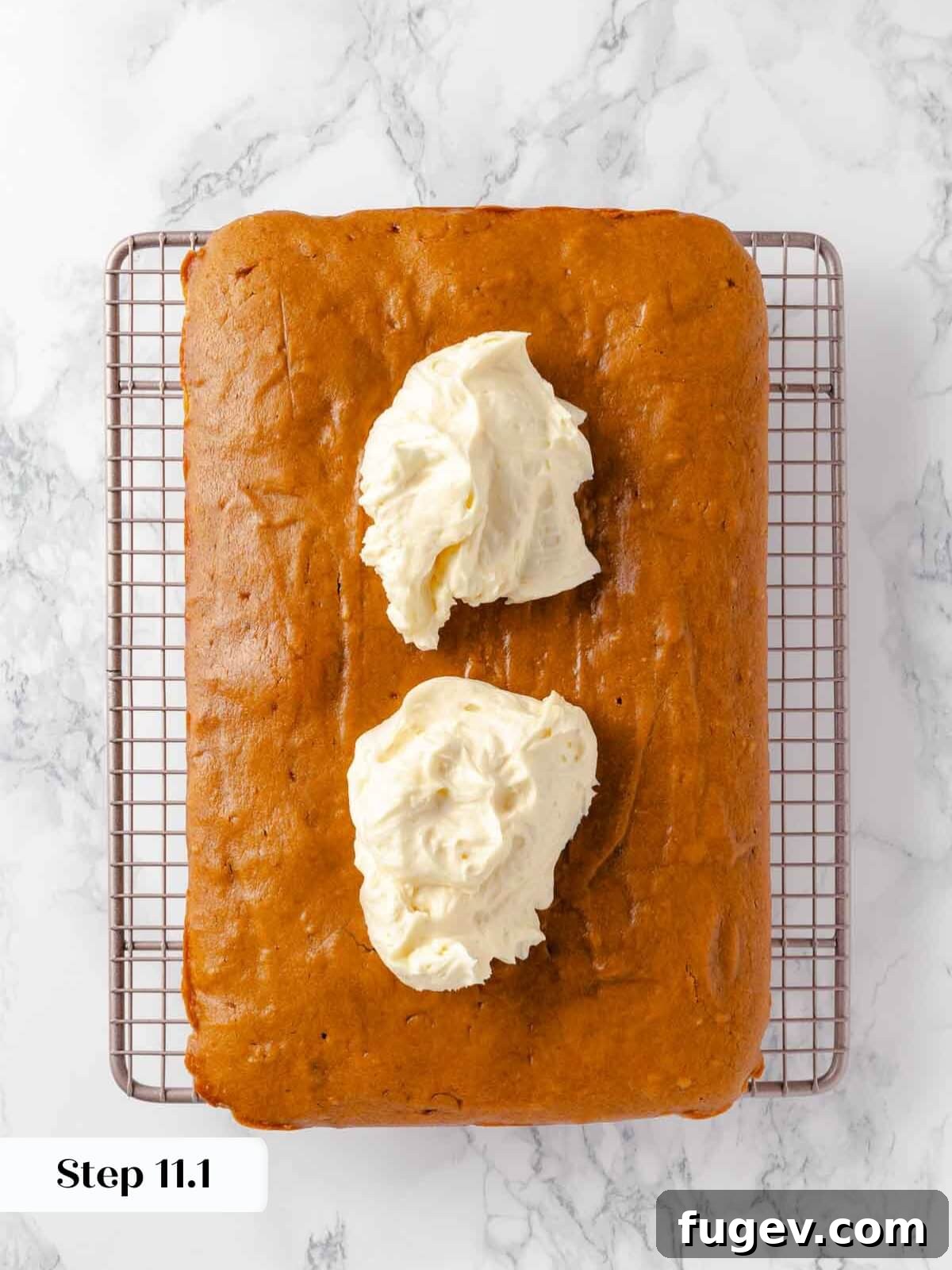Autumn Pumpkin Spice Squares 15 Generous dollops of creamy cream cheese frosting are placed on top of the cooled pumpkin bars, ready to be spread.