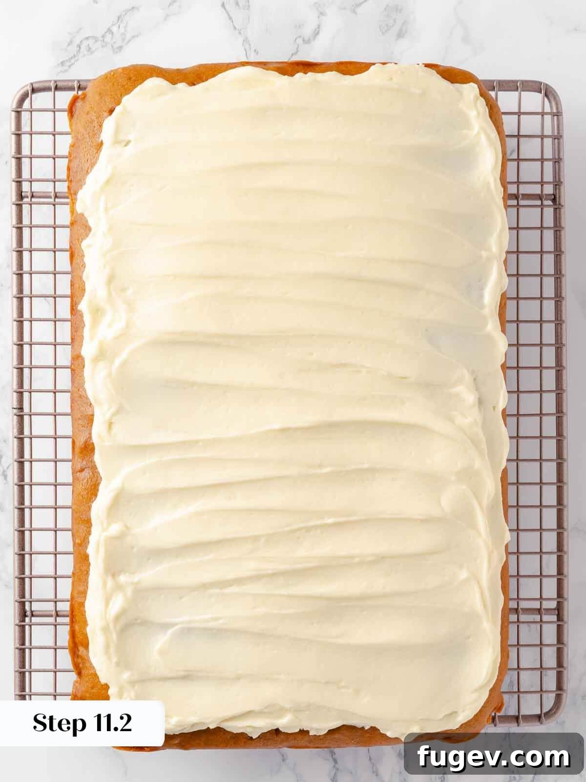 Autumn Pumpkin Spice Squares 16 An offset spatula smoothly spreads the cream cheese frosting across the surface of the pumpkin bars, creating an even, inviting layer.