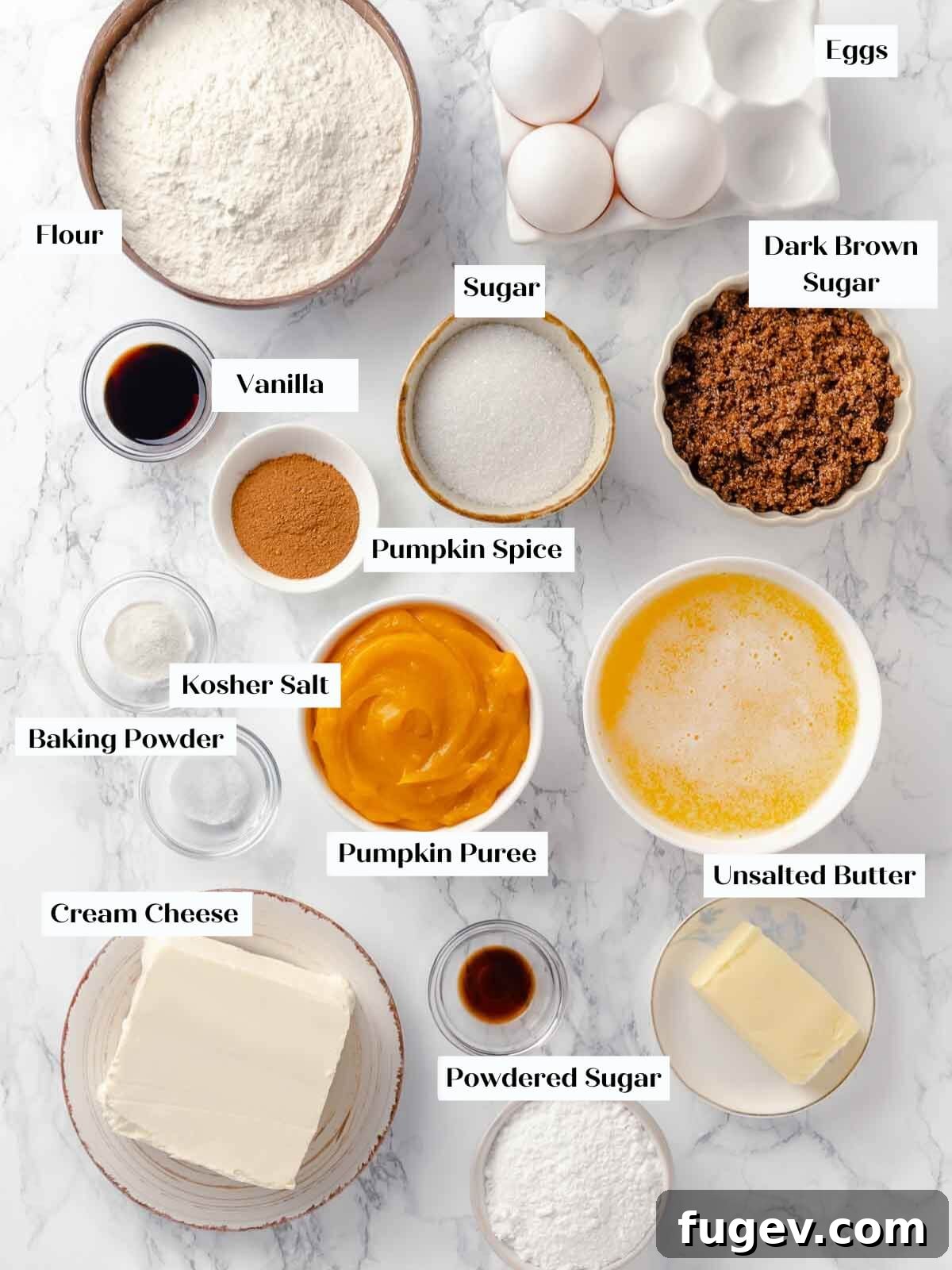 Autumn Pumpkin Spice Squares 4 A collection of fresh, high-quality ingredients for pumpkin bars, neatly arranged on a white marble surface, including pumpkin puree, spices, flour, and eggs.