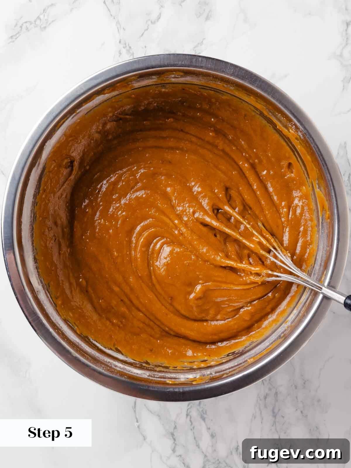 Autumn Pumpkin Spice Squares 8 Pumpkin puree is being added to the wet mixture, enriching the pumpkin bar batter with its vibrant color and flavor.