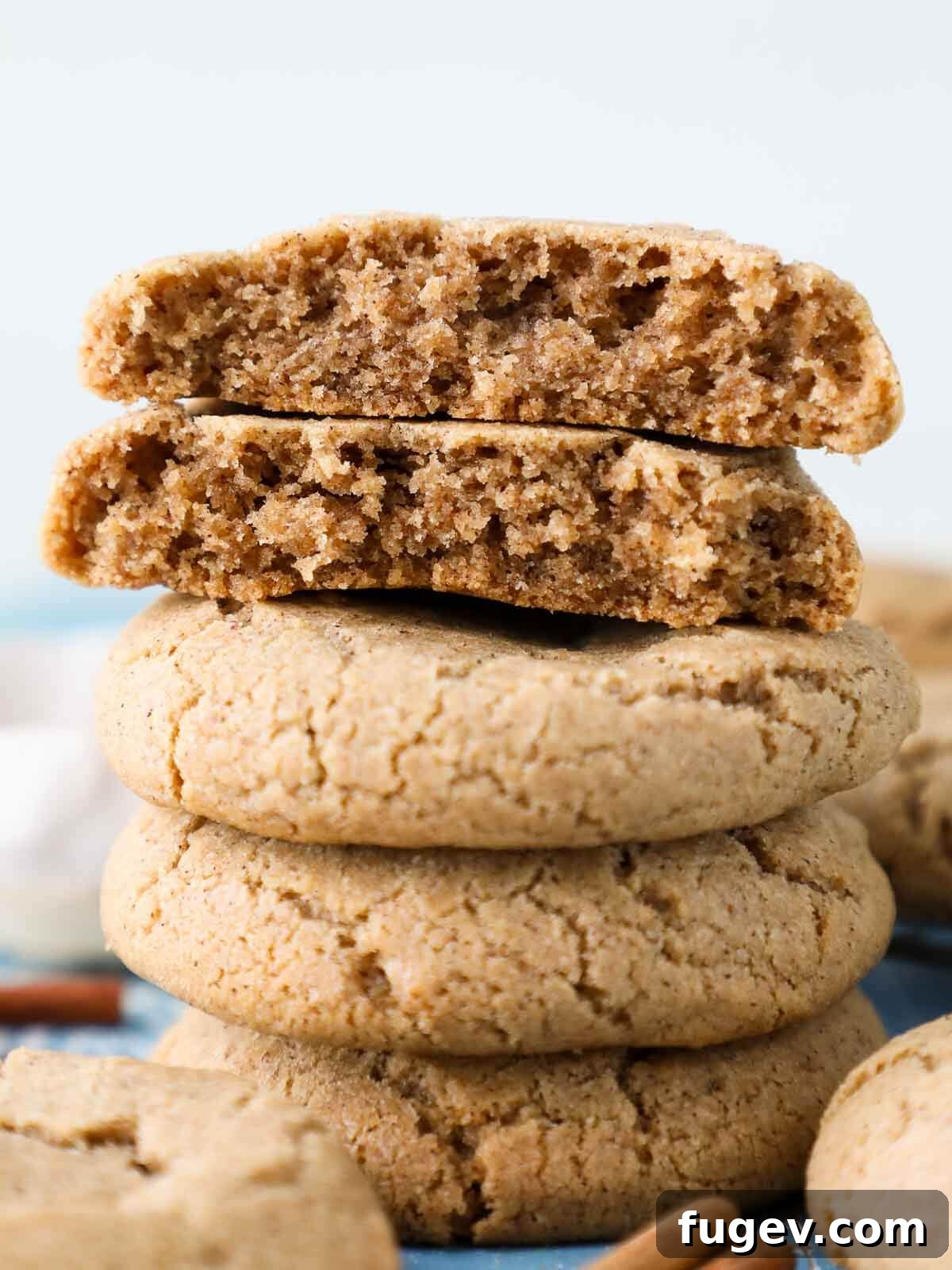 Sparkling Cinnamon Delights 2 A beautifully arranged stack of golden brown cinnamon sugar cookies, each with delicate crackled tops, invitingly presented.