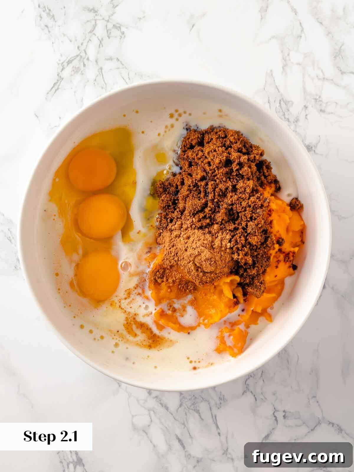 No-Fuss Pumpkin Dump Cake 5 Individual ingredients for the pumpkin dump cake filling, including raw eggs, pumpkin puree, and spices, laid out before mixing.