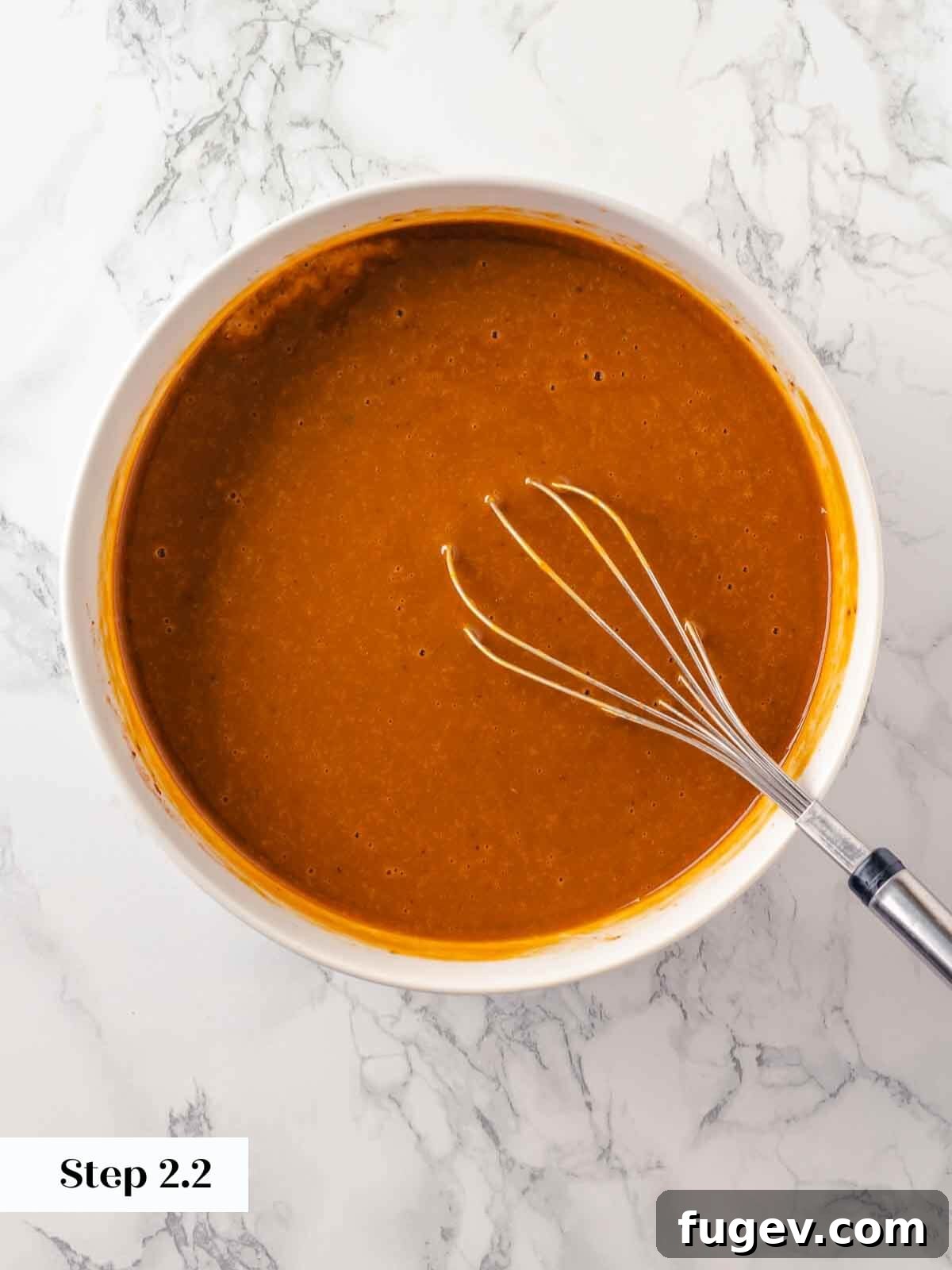 No-Fuss Pumpkin Dump Cake 6 A smooth, creamy mixture of whisked pumpkin dump cake ingredients in a glass bowl, ready for the baking dish.