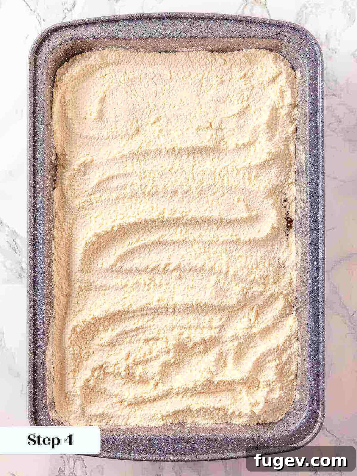 No-Fuss Pumpkin Dump Cake 8 Dry yellow cake mix carefully spread in an even layer over the pumpkin filling in the baking dish, ready for the next steps.
