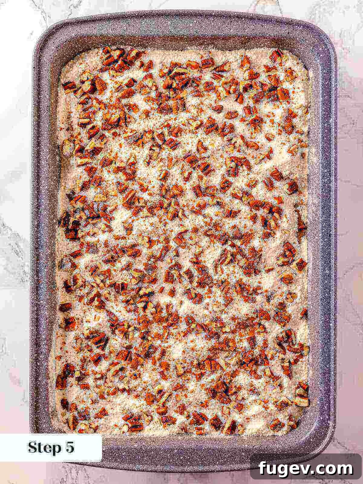No-Fuss Pumpkin Dump Cake 9 Chopped pecans generously sprinkled over the dry cake mix layer in the pumpkin dump cake, creating a crunchy texture.