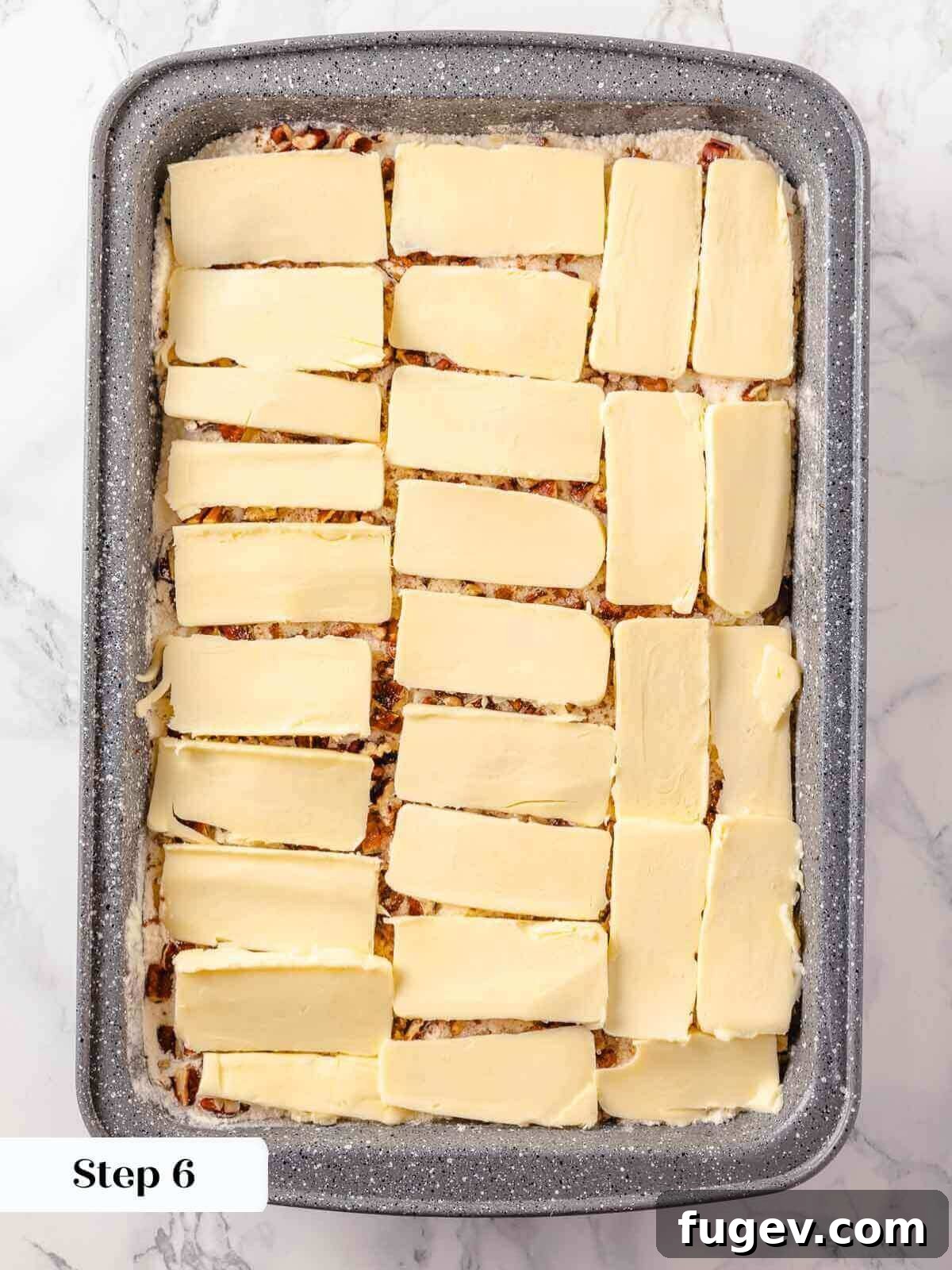 No-Fuss Pumpkin Dump Cake 10 Thin slices of unsalted butter carefully arranged in a single layer over the pecan and cake mix topping of the pumpkin dump cake before baking.