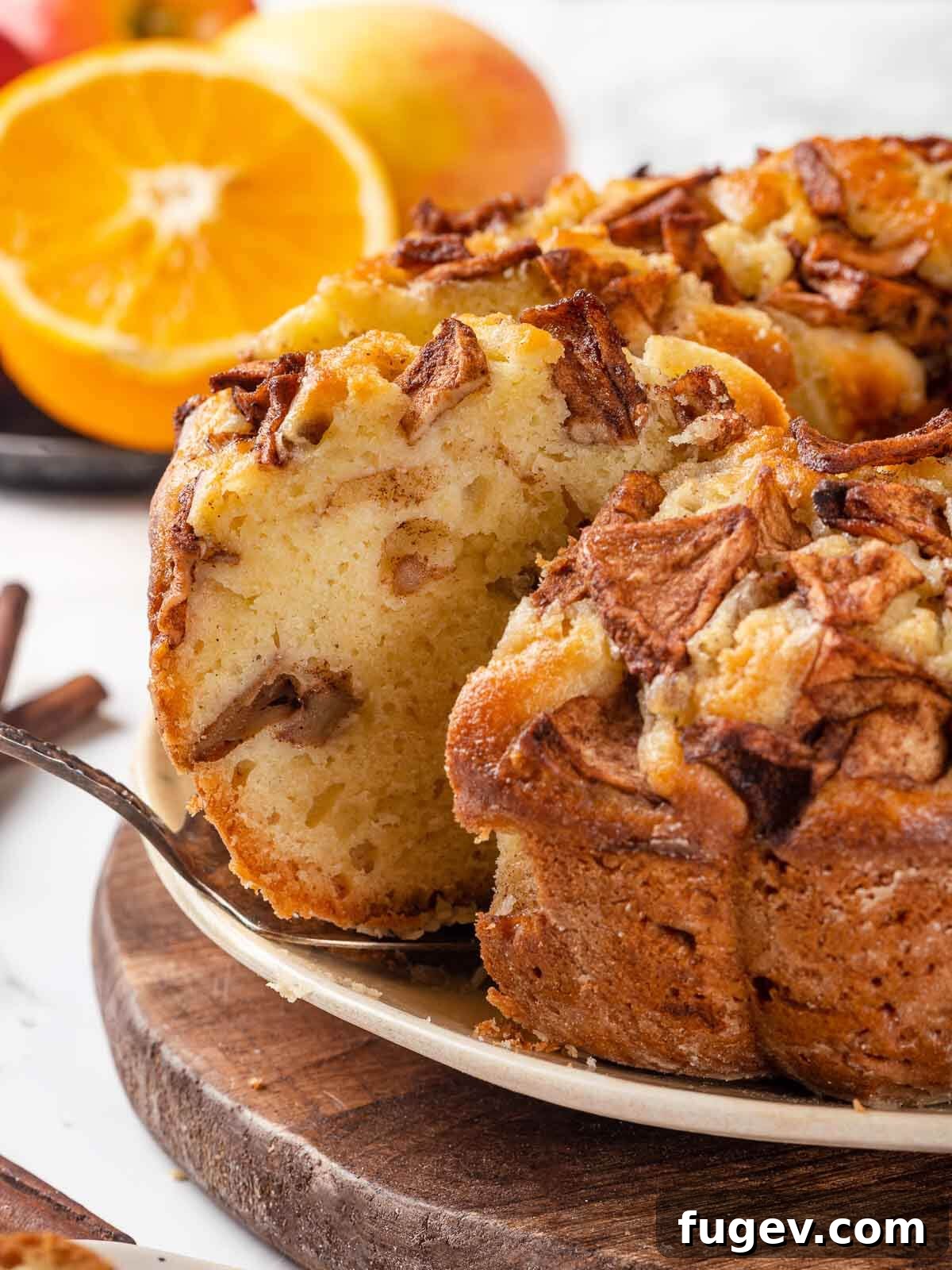 Grandma's Jewish Apple Cake 2 A slice of Jewish apple cake with a silver cake server, highlighting its moist texture and apple layers.