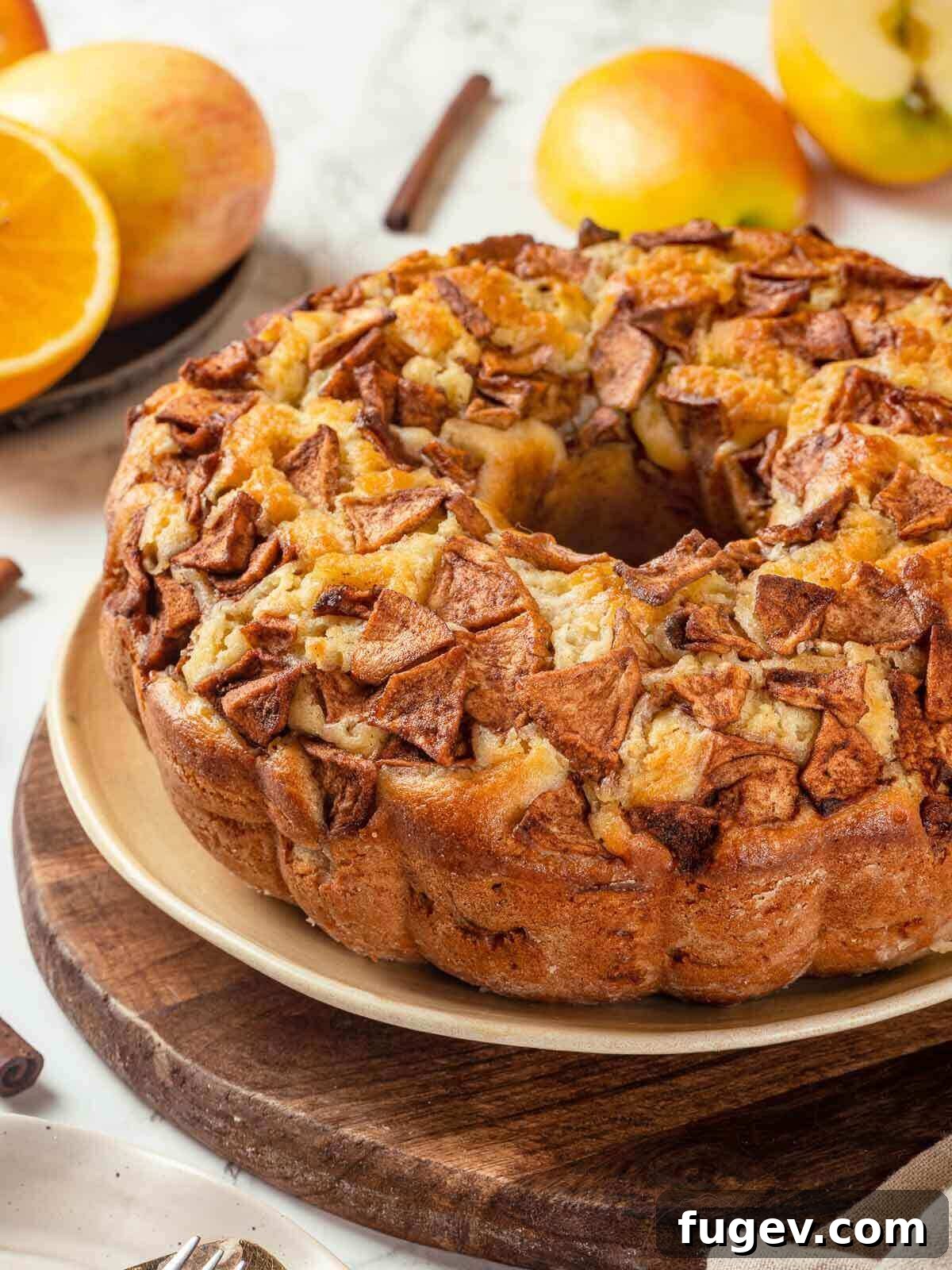 Grandma's Jewish Apple Cake 3 A beautifully baked Jewish apple cake presented on an elegant wooden cake stand.