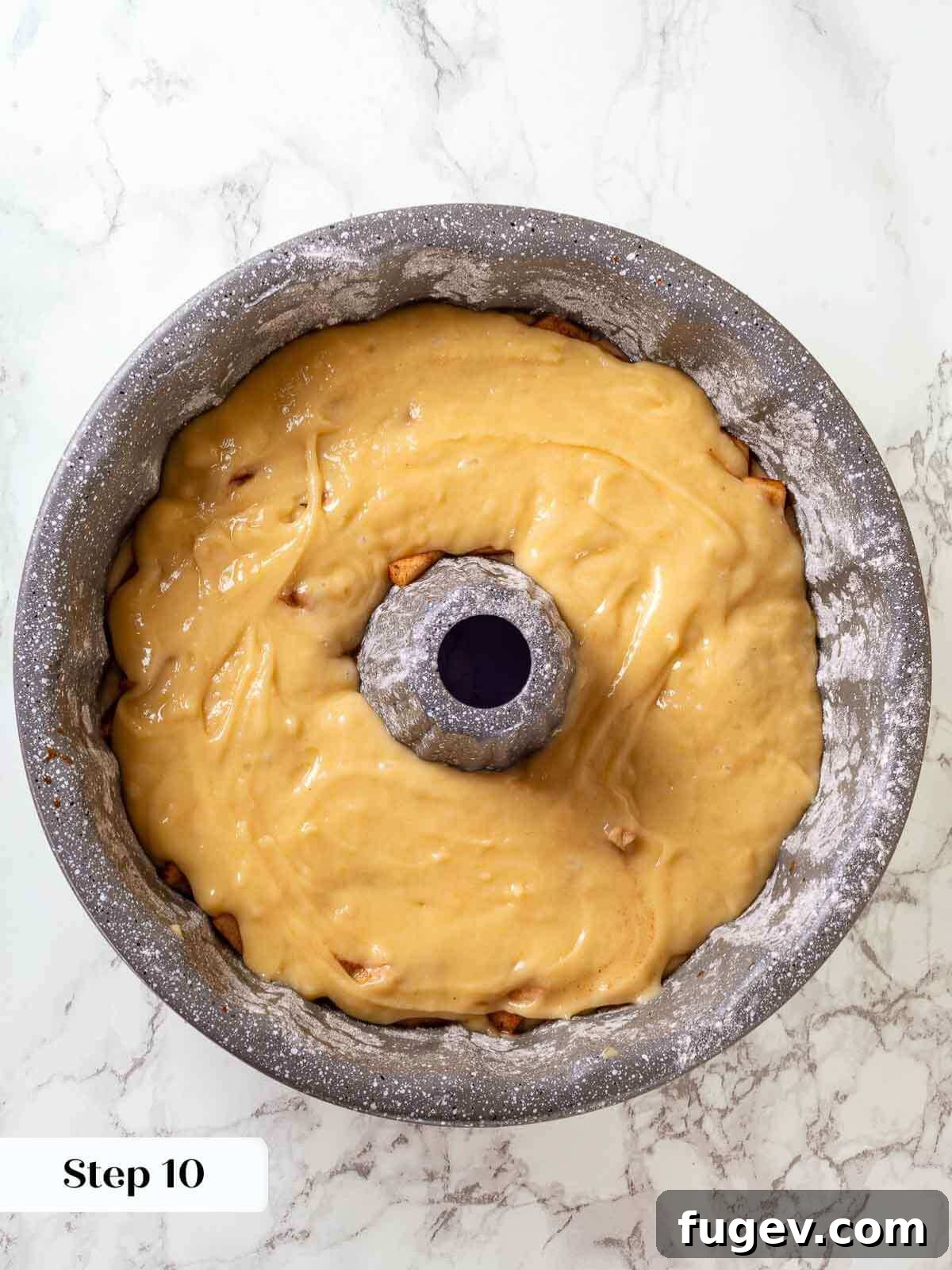 Grandma's Jewish Apple Cake 9 Second layer of cake batter poured over the first apple layer in the pan.
