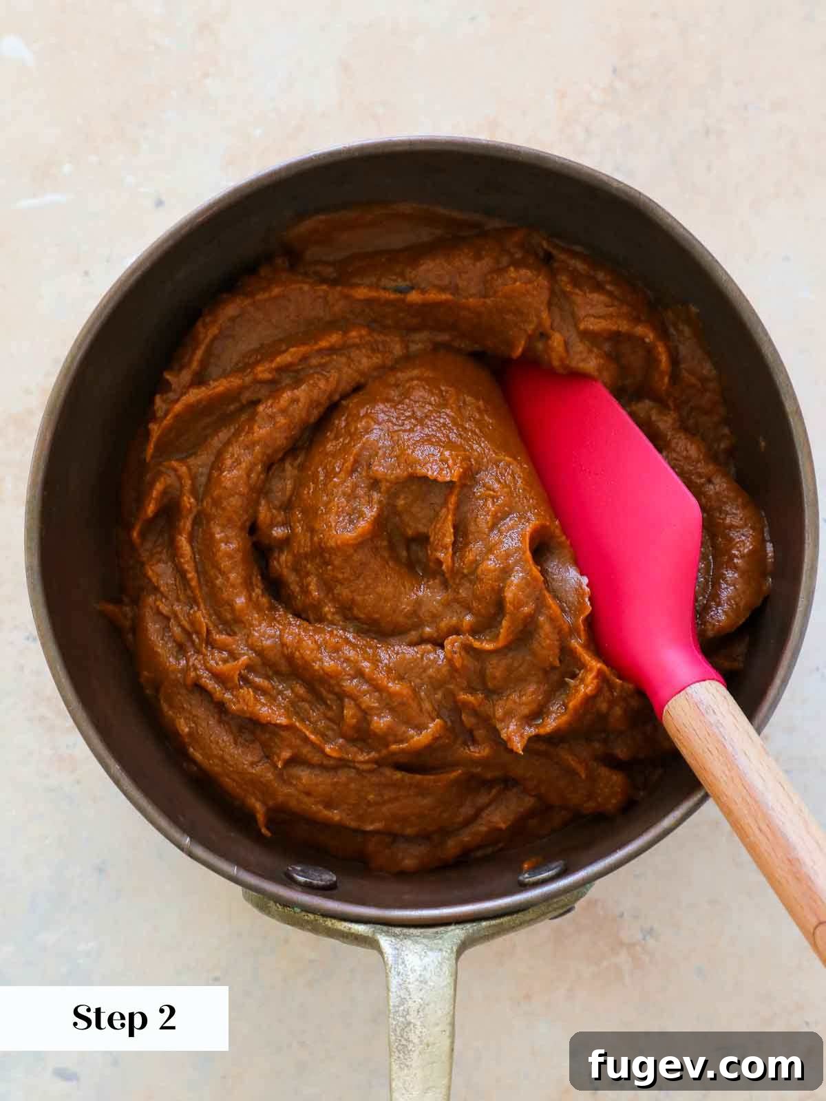 Cozy Spiced Pumpkin Butter 5 Thick, rich pumpkin butter simmering in a rustic copper pot, indicating a perfect cook.