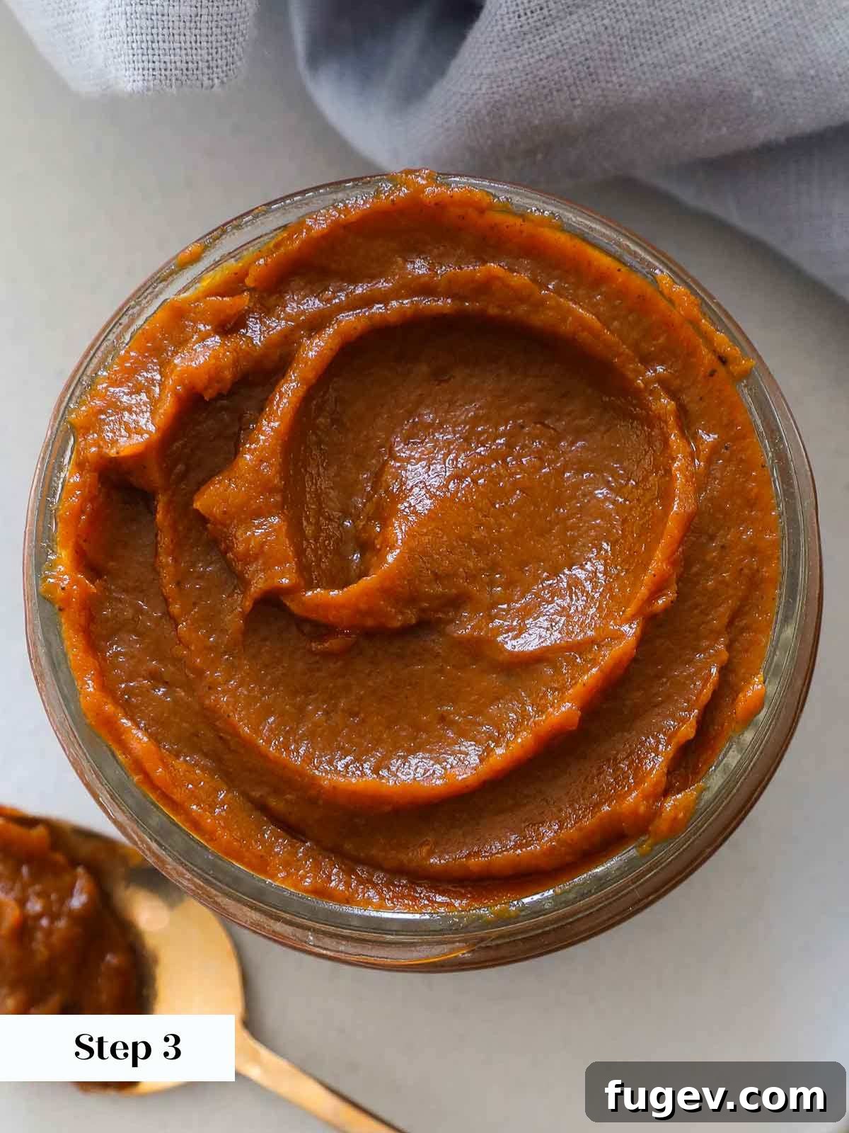 Cozy Spiced Pumpkin Butter 6 A beautifully jarred pumpkin butter with a delightful swirl on top, ready for storage or gifting.