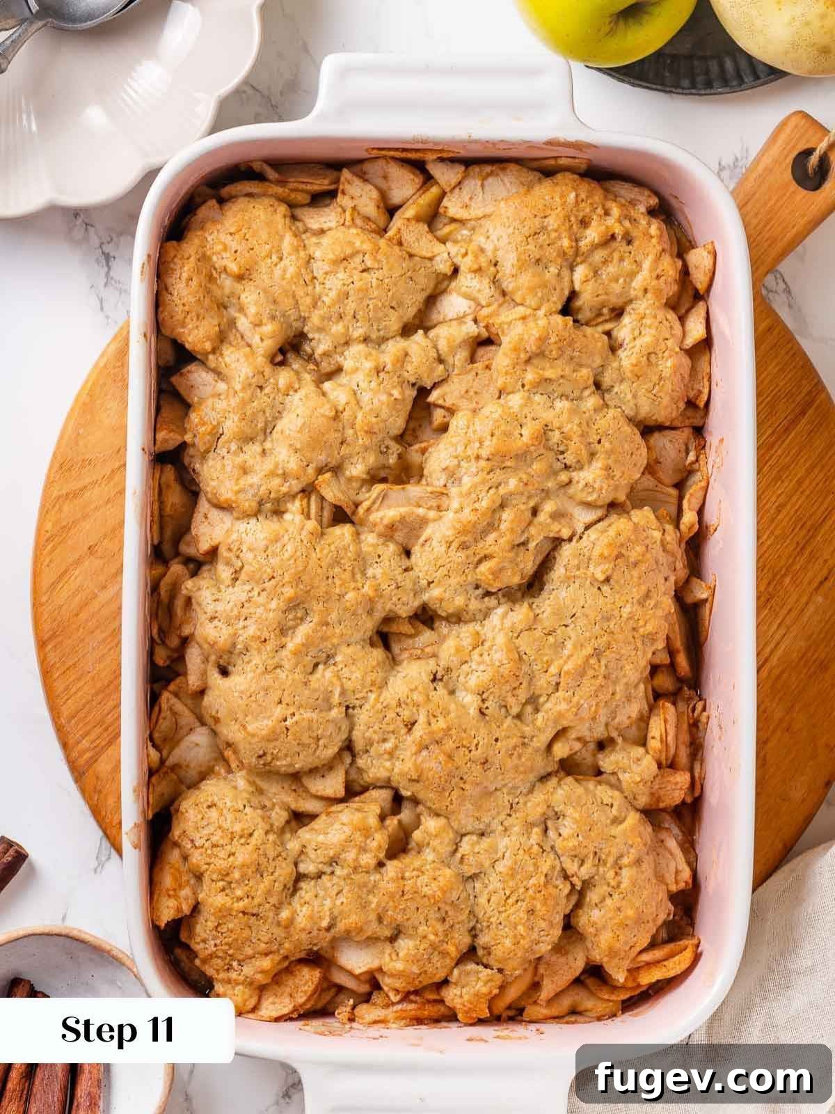 Cozy Apple Cobbler Magic 12 The fully baked apple cobbler, featuring a perfectly golden brown biscuit topping and bubbly fruit filling, indicating it's ready to serve.