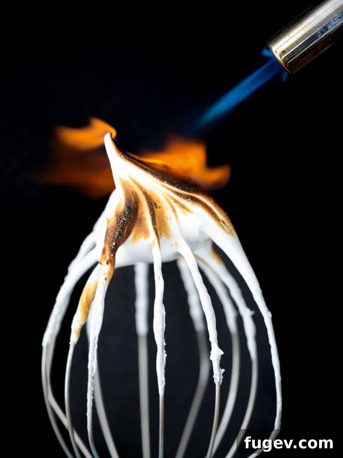Gifts to Delight Any Home Cook 11 A butane torch expertly caramelizing the surface of frosting on a dessert, demonstrating a professional finishing technique.