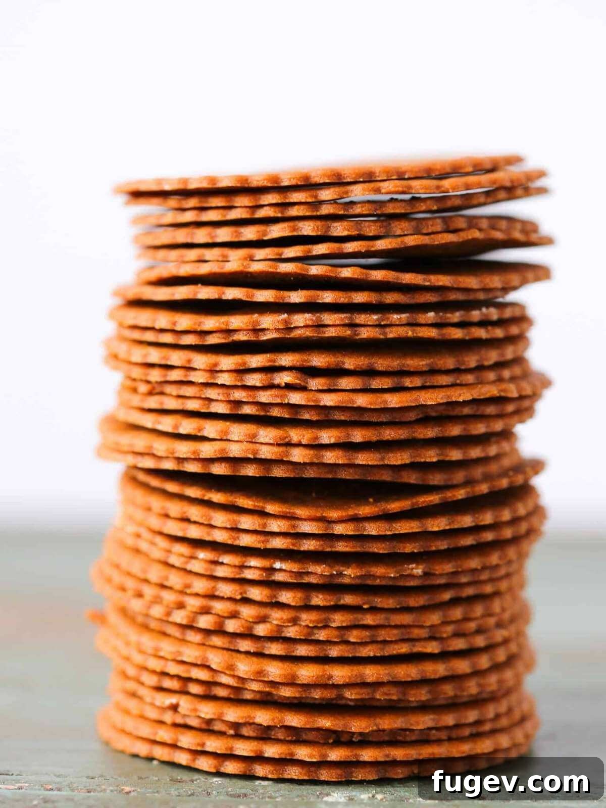 Gifts to Delight Any Home Cook 5 A perfectly neat stack of ultra-thin, crispy Moravian cookies, elegantly arranged and ready for festive holiday snacking or gifting.