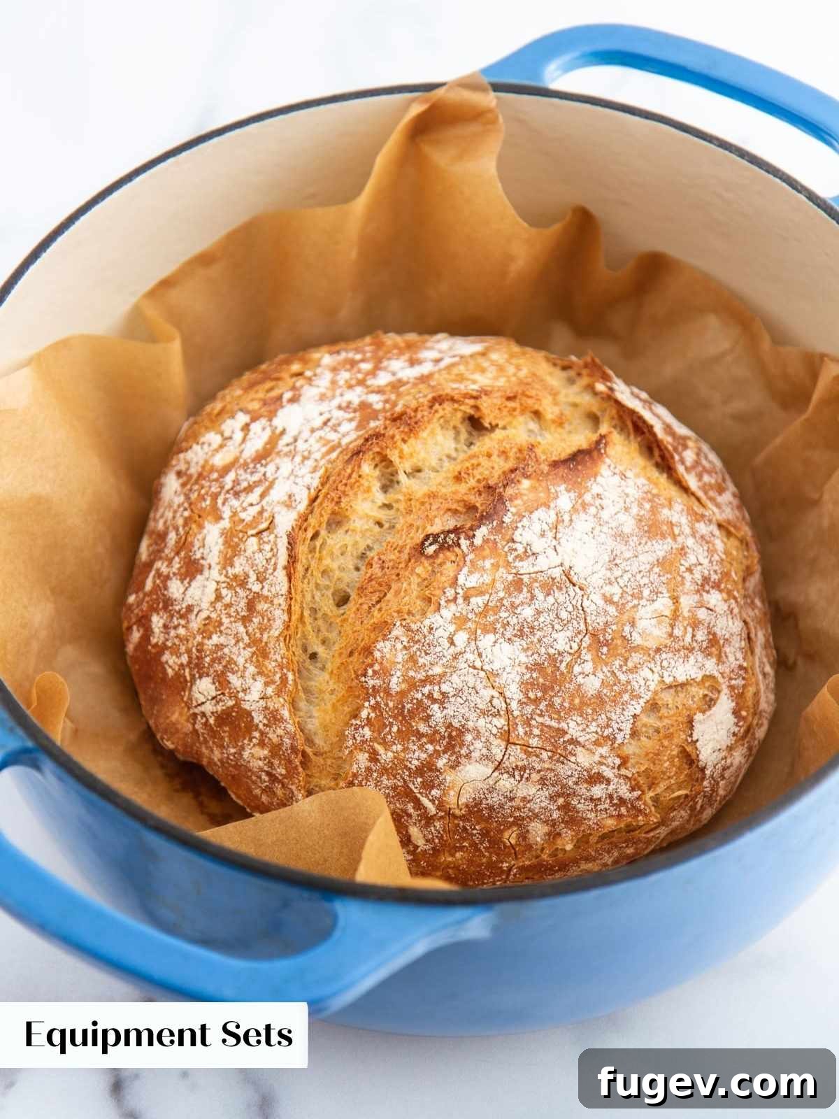Gifts to Delight Any Home Cook 8 A rustic loaf of freshly baked, crusty bread nestled in a vibrant blue Le Creuset Dutch oven, exuding warmth and home-baked goodness.
