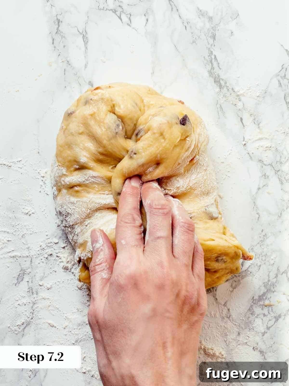 Traditional Italian Panettone 13 Panettone dough being gently folded during the pre-shaping process, creating tension and structure.
