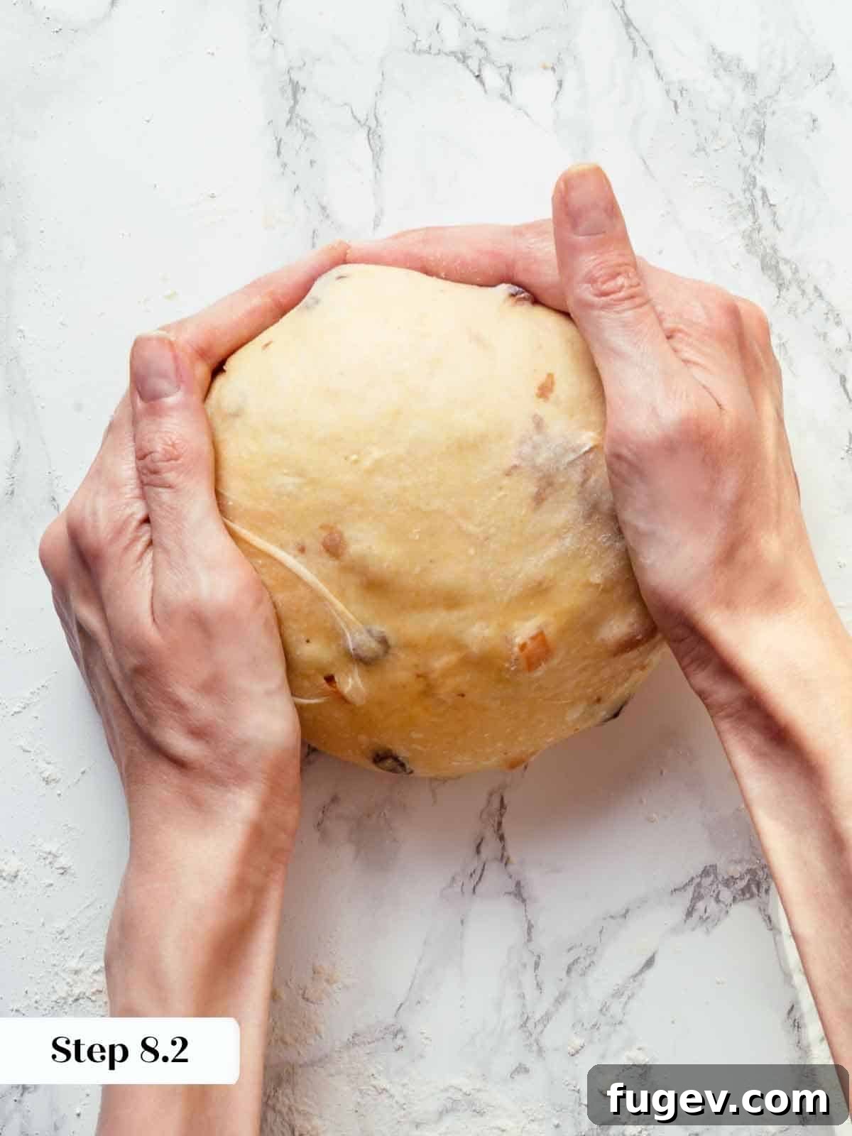 Traditional Italian Panettone 15 Skilled hands shaping and tightening panettone dough into a smooth, taut ball, ready for its final proof.