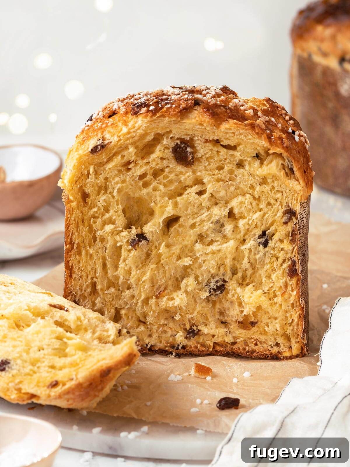 Traditional Italian Panettone 19 A golden-brown loaf of baked panettone, expertly sliced to reveal its incredibly fluffy, airy, and fruit-studded interior.