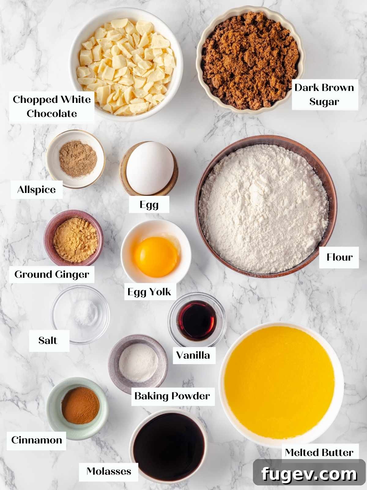 Chewy Gingerbread Blondies 4 All the dry and wet ingredients for gingerbread blondies meticulously laid out on a white marble countertop, showcasing flour, spices, butter, molasses, and brown sugar.