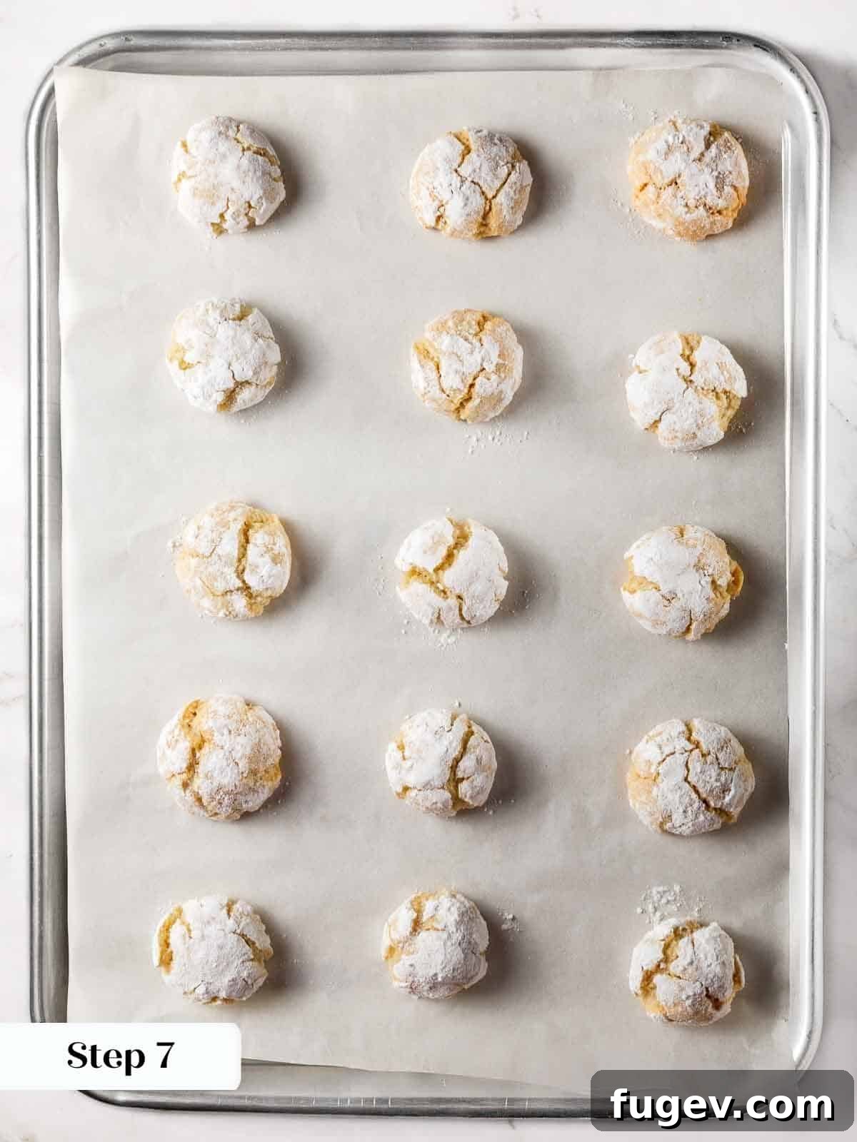 Italian Almond Amaretti 11 Freshly baked soft amaretti cookies with beautiful crinkles, cooling on a baking sheet.