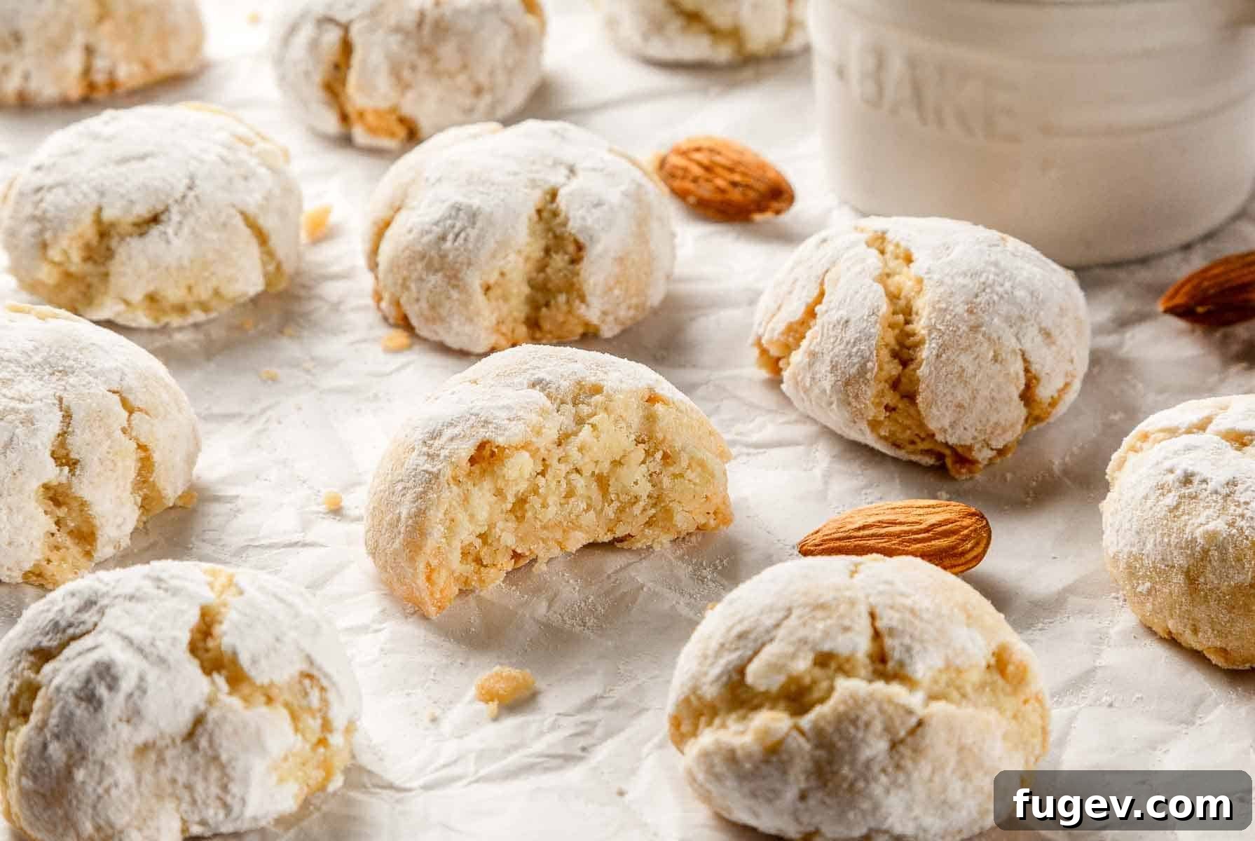 Italian Almond Amaretti 3 Close-up of soft amaretti cookies on a baking sheet, showing their crinkled tops and light golden brown edges.