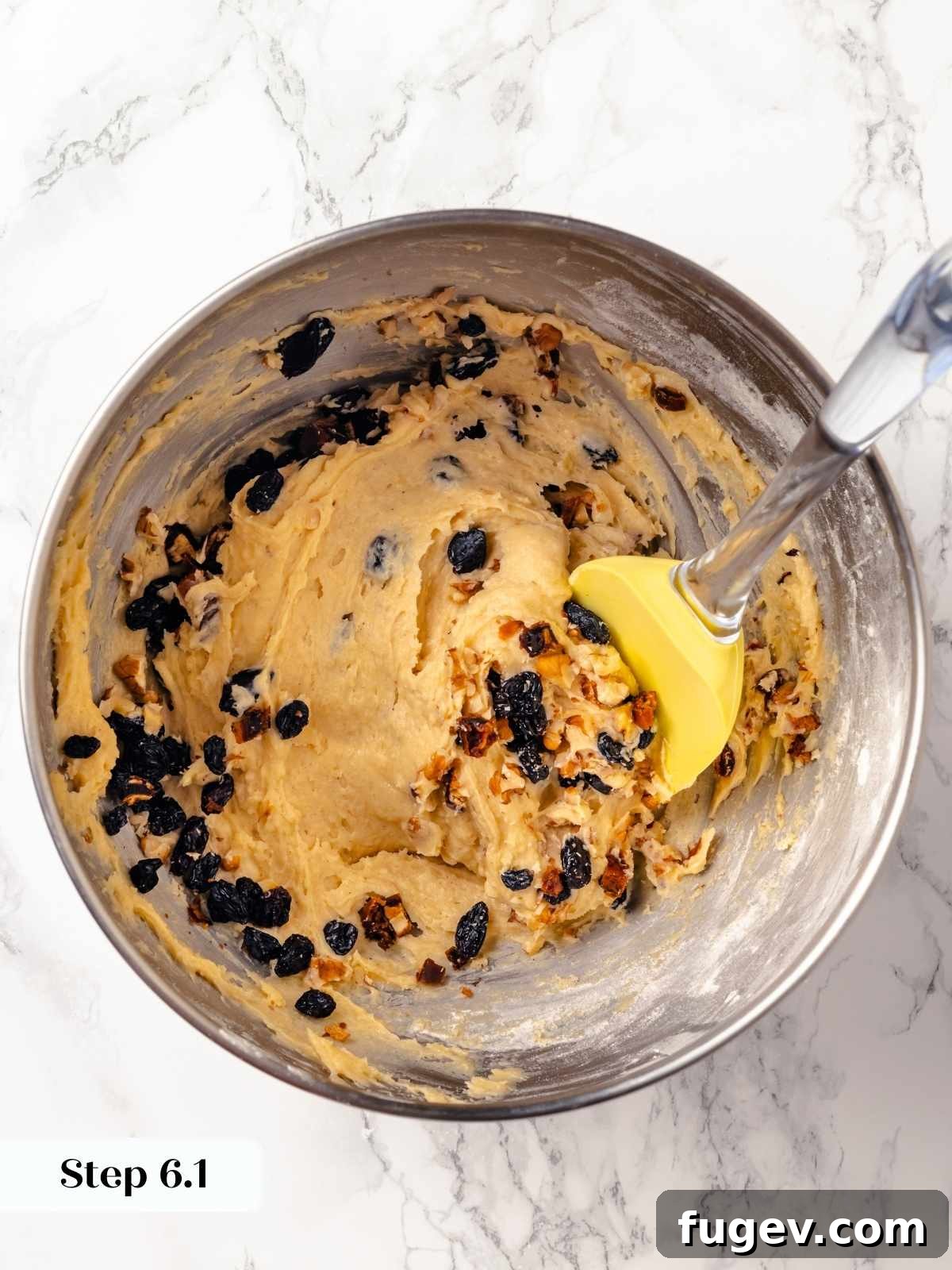 Old Fashioned Spiced Hermit Bars 13 A spatula folding dried fruit and nuts into hermit cookie dough.