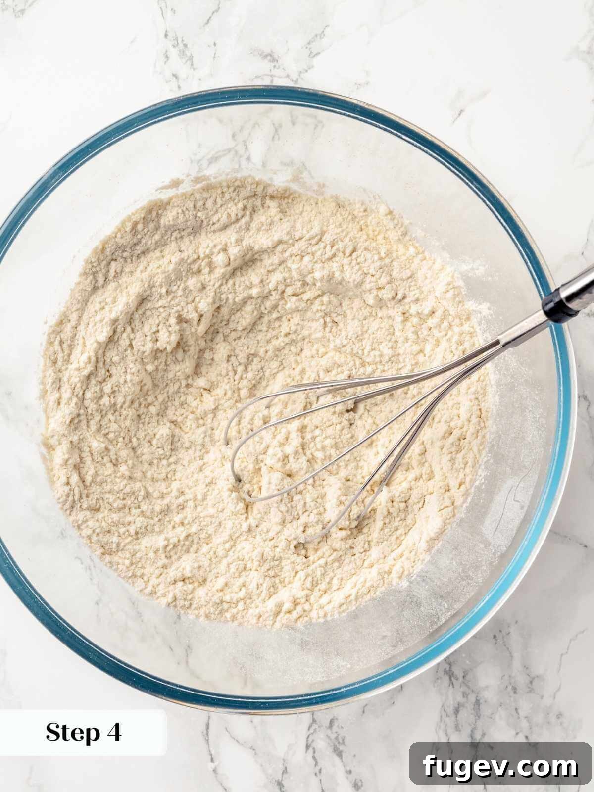 Old Fashioned Spiced Hermit Bars 10 A whisk blending together the dry ingredients like flour, spices, and leavening agents.
