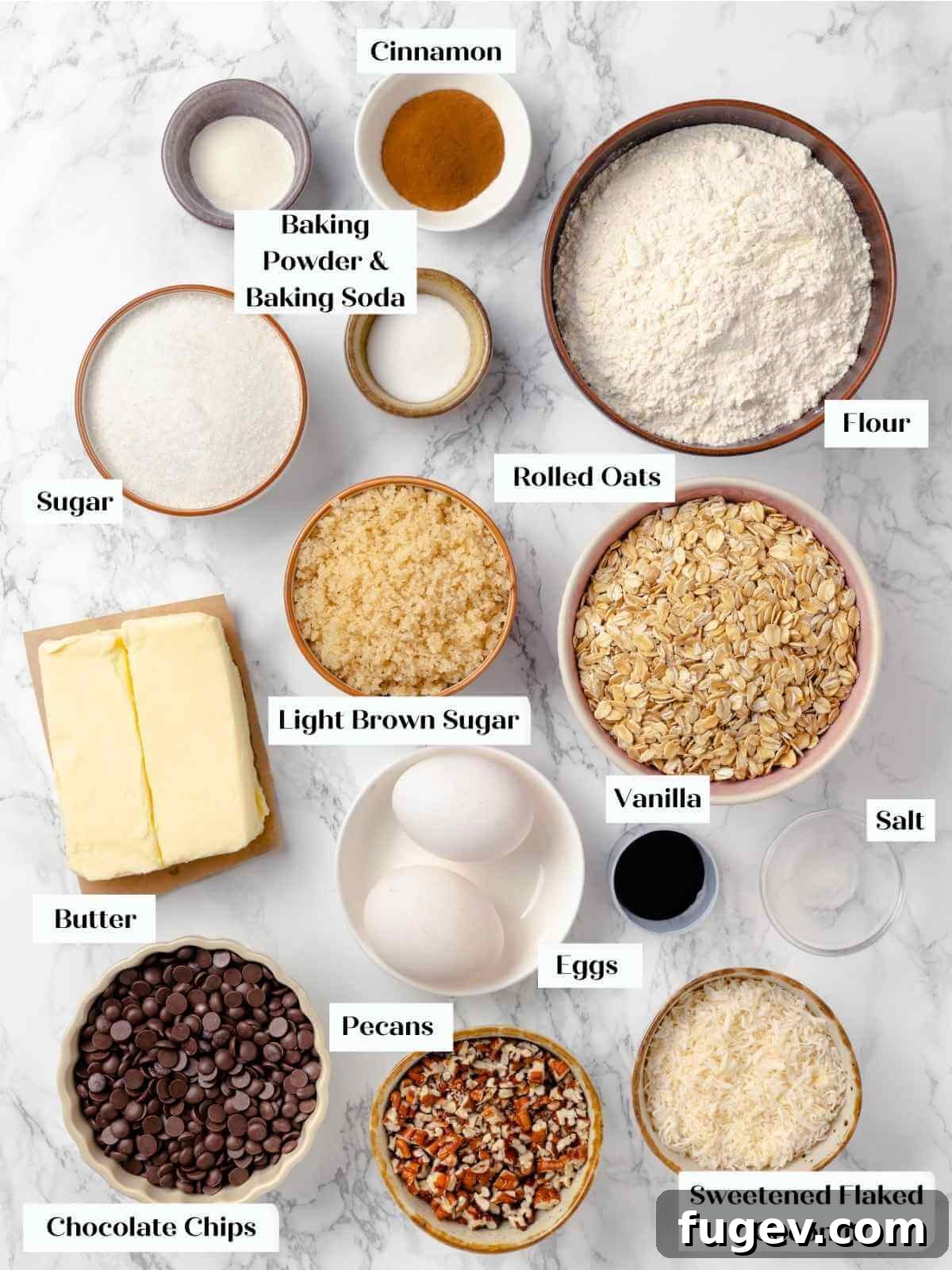 Hearty Cowboy Cookies 4 A beautifully arranged flat lay of all the essential ingredients for cowboy cookies, neatly organized on a clean white marble countertop.