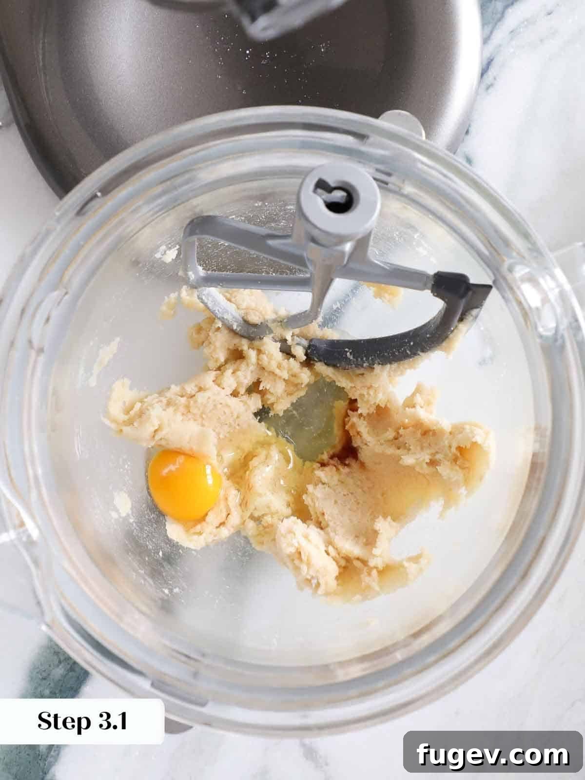 Ultimate Monster Cookies 7 A raw egg cracked into a mixing bowl, ready to be combined with other monster cookie ingredients.