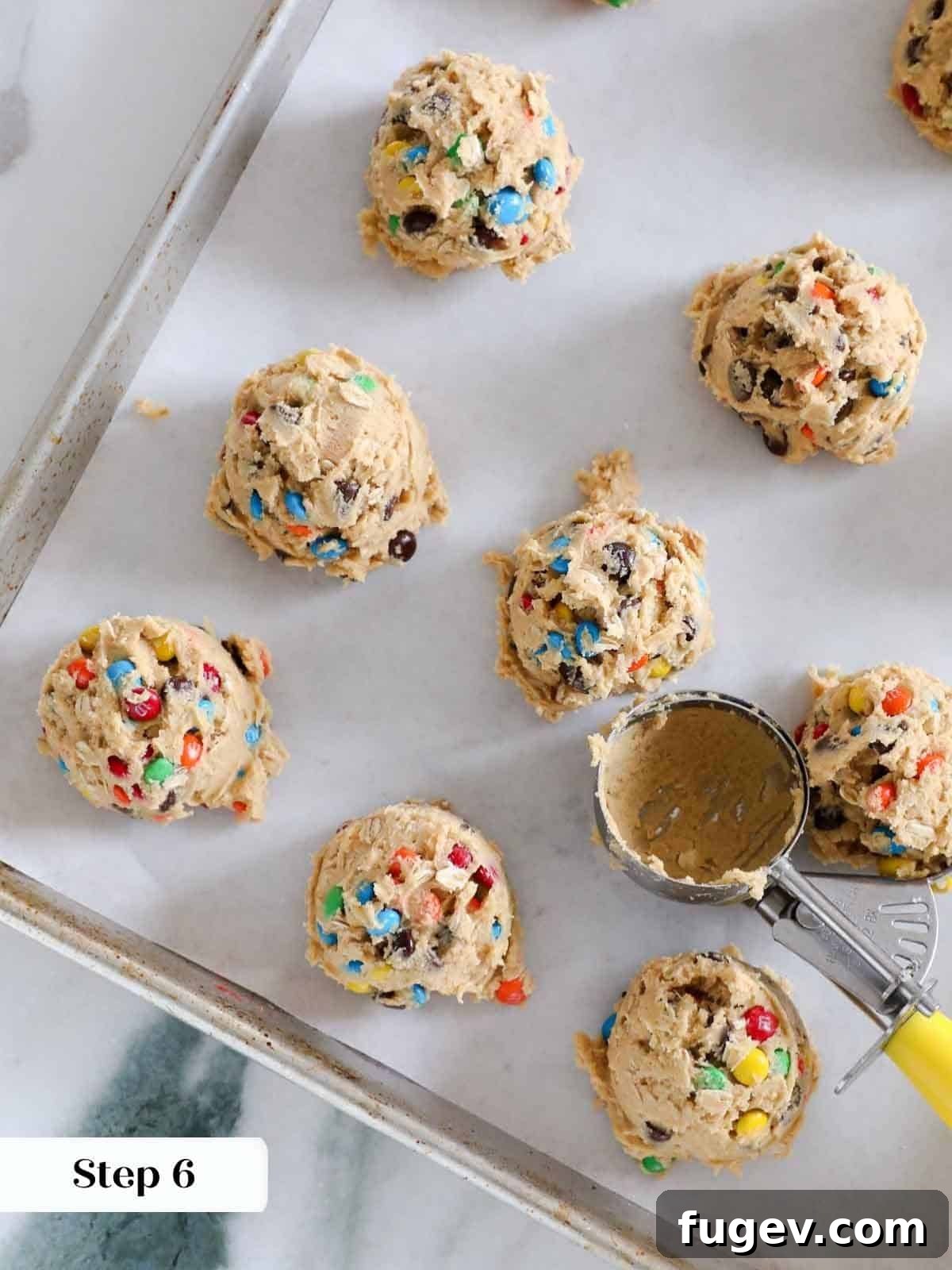 Ultimate Monster Cookies 10 Scooped portions of monster cookie dough placed evenly on a baking sheet.