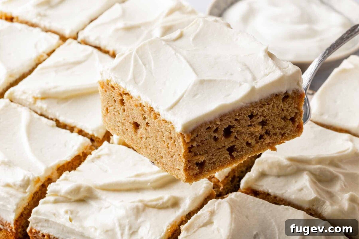 Luscious Banana Cake with Tangy Cream Cheese Frosting 4 A beautifully frosted banana cake being served with a cake server, ready for guests.