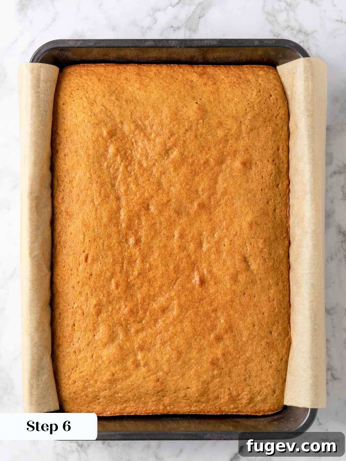 Luscious Banana Cake with Tangy Cream Cheese Frosting 8 A freshly baked banana cake cooling in its pan, showing a golden-brown top and moist edges.