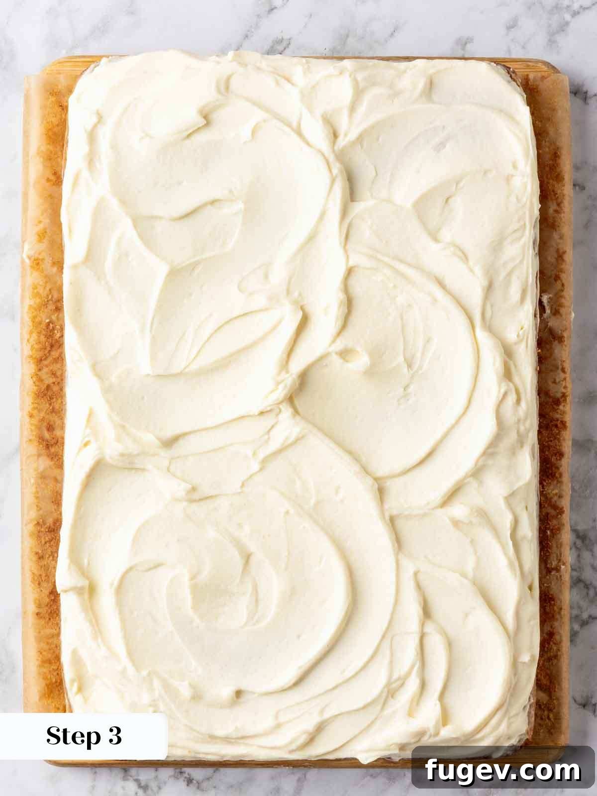 Luscious Banana Cake with Tangy Cream Cheese Frosting 10 A delicious banana cake beautifully topped with swirled cream cheese frosting, showcasing its inviting creamy texture.