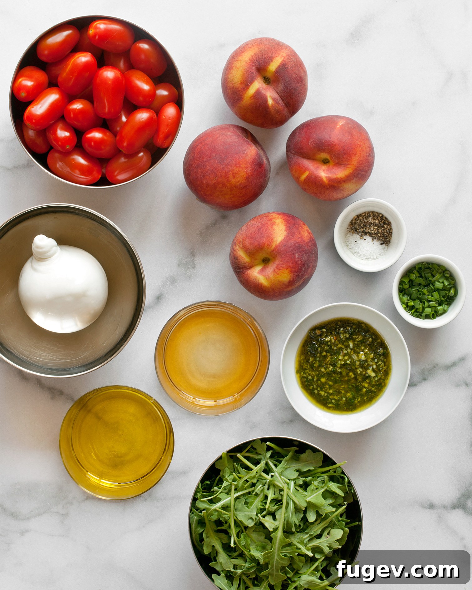Sun-Kissed Peach, Tomato & Burrata Salad 4 A flat lay photograph displaying the fresh ingredients required for the salad, including peaches, tomatoes, burrata, arugula, and chives.